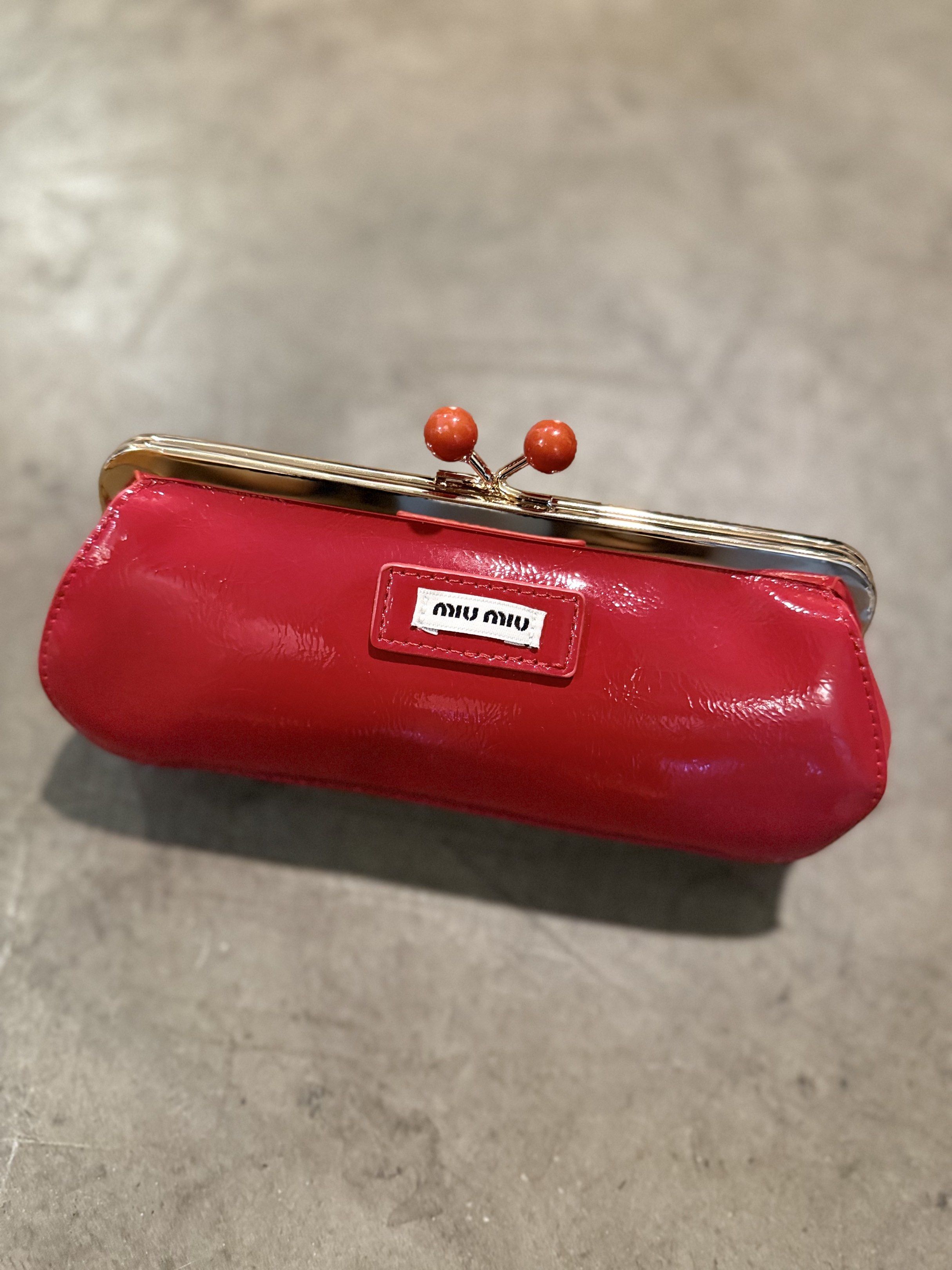 Miu Miu Patent Leather Clutch (Category: Luxury Bags & Wallets) located in Cebu City. Submitted by conyosh (Listing ID 1418078705, Image 3). Description: - Miu Miu clutch in patent leather - Available colors: Red and Blue - Features a kiss-lock closure - Decorative accents - Miu Miu logo on the front - Perfect for any occasion.