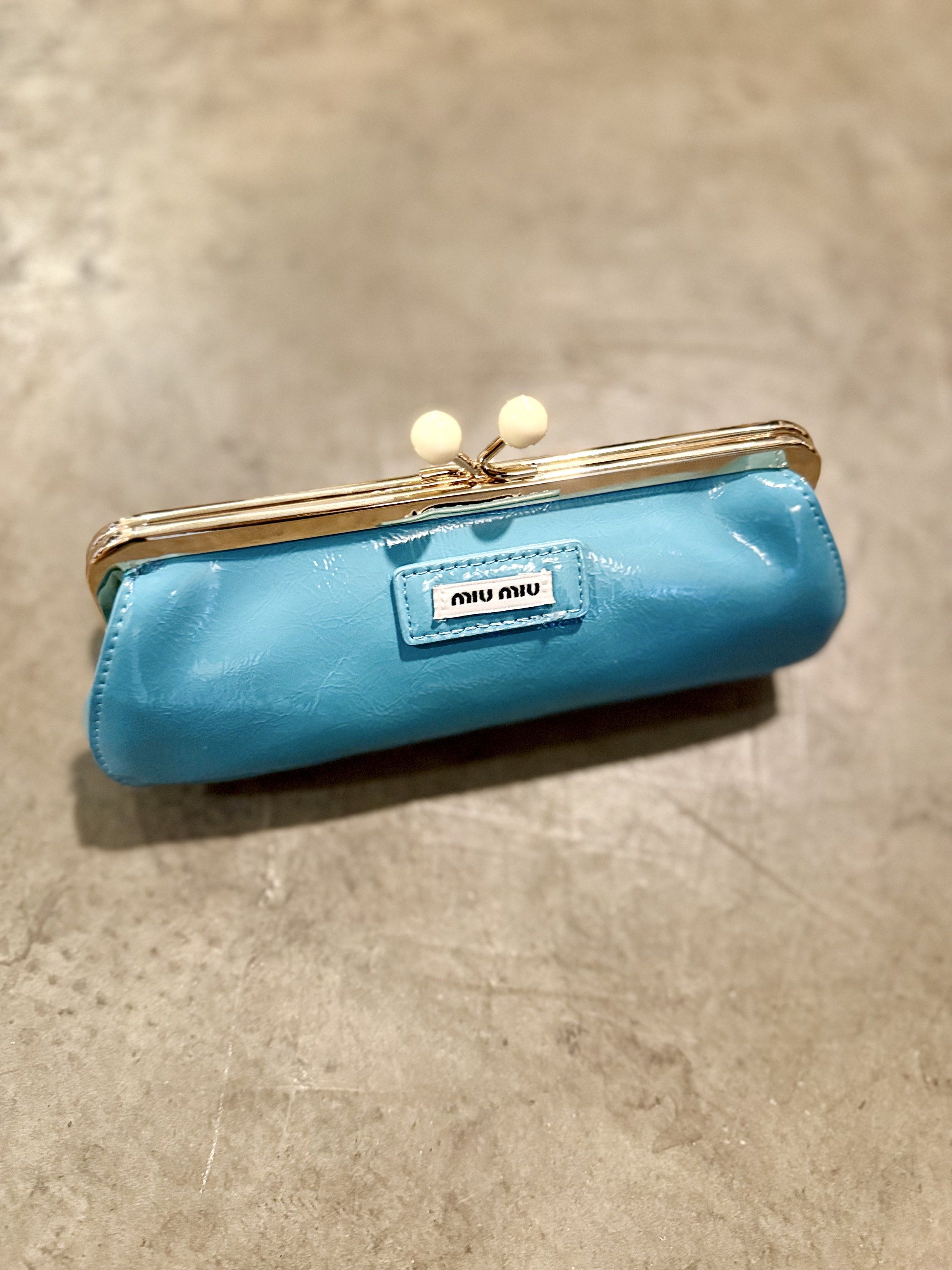 Miu Miu Patent Leather Clutch (Category: Luxury Bags & Wallets) located in Cebu City. Submitted by conyosh (Listing ID 1418078705, Image 2). Description: - Miu Miu clutch in patent leather - Available colors: Red and Blue - Features a kiss-lock closure - Decorative accents - Miu Miu logo on the front - Perfect for any occasion.