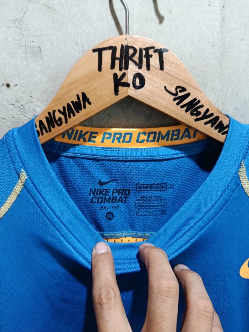 Nike Pro Combat XL Shirt (Category: Activewear) located in Kalamansig. Submitted by skone1996 (Listing ID 1418093214, Image 3). Description: - Nike Pro Combat shirt - Color: Blue and orange - Size: XL - 16 Width - 27 Length - Crew neck, short sleeves - Nike logo on chest - Pro Combat branding on back and neckline - Dri-FIT technology.