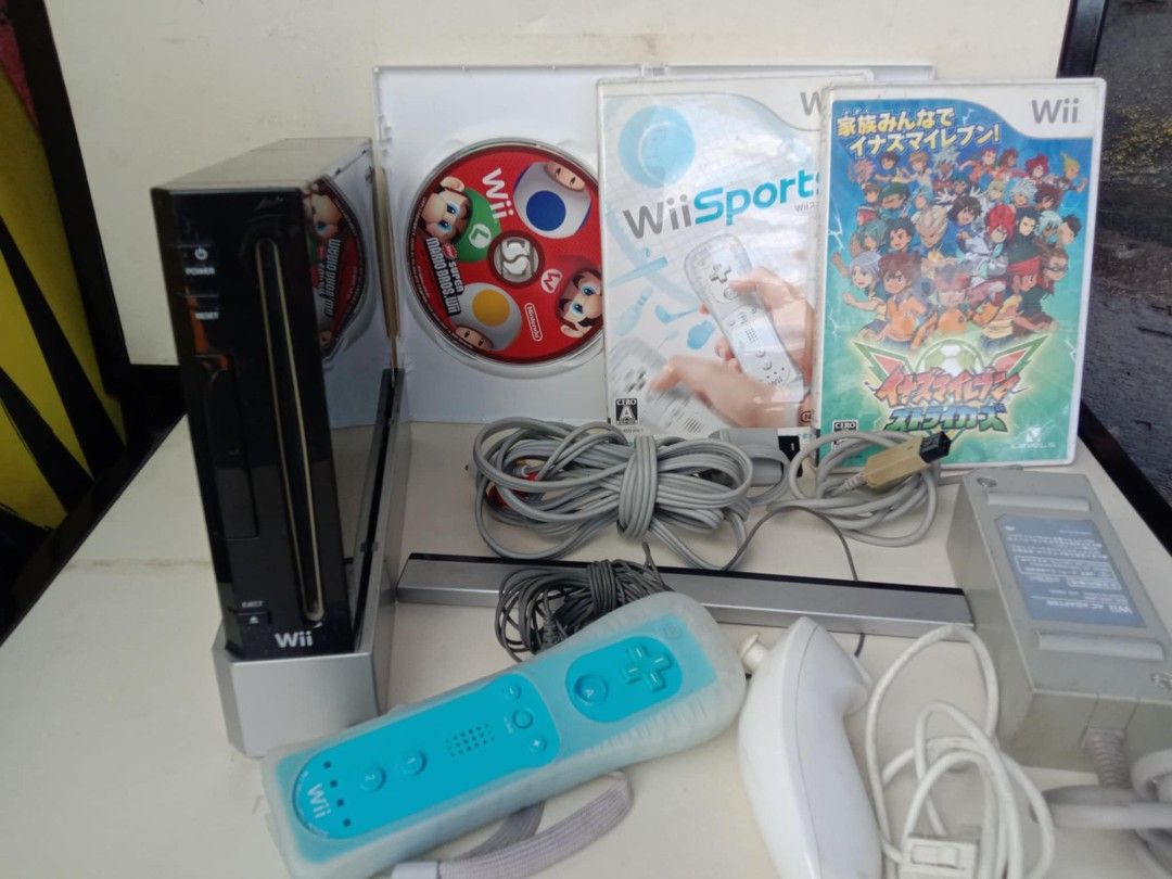 Nintendo Wii Console with Games (Category: Nintendo) located in Quezon City. Submitted by jpnvintageonline (Listing ID 1418086839, Image 2). Description: - Nintendo Wii console with accessories - Includes: console, 2 controllers, sensor bar, power adapter, and cables - Games included: Wii Sports, Mario Party 8, and a game with Japanese text.