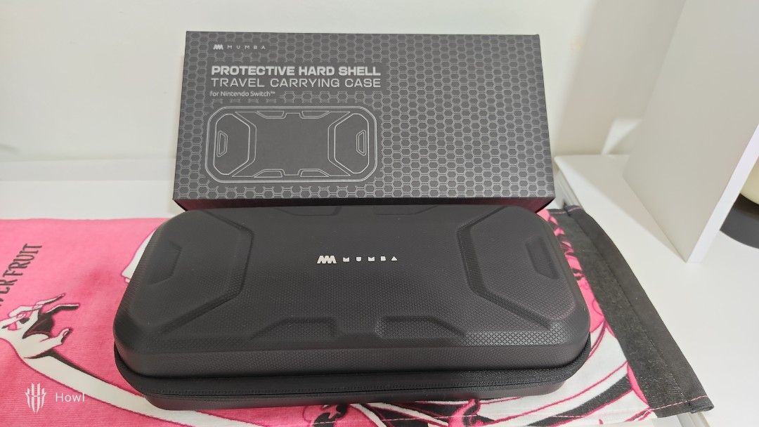 [NO ISSUE] Mumba Plus Protective Hard Shell Travel Carrying Case (Category: Cases & Sleeves) located in Antipolo. Submitted by behowling (Listing ID 1418018572, Image 1). Description: Newly bought, fits mobapad, complete and NO DAMAGE RFS: Wanted a slimmer storage - Protective hard shell case for Nintendo Switch Oled - Features a zippered compartment for accessories - Separate compartment for the console - Black with textured exterior.