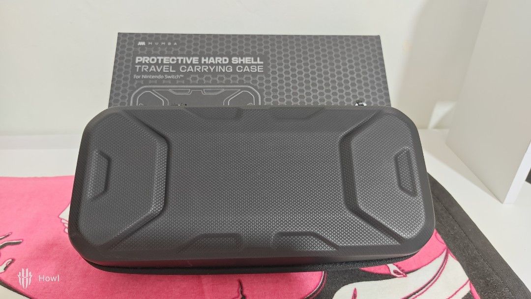 [NO ISSUE] Mumba Plus Protective Hard Shell Travel Carrying Case (Category: Cases & Sleeves) located in Antipolo. Submitted by behowling (Listing ID 1418018572, Image 3). Description: Newly bought, fits mobapad, complete and NO DAMAGE RFS: Wanted a slimmer storage - Protective hard shell case for Nintendo Switch Oled - Features a zippered compartment for accessories - Separate compartment for the console - Black with textured exterior.