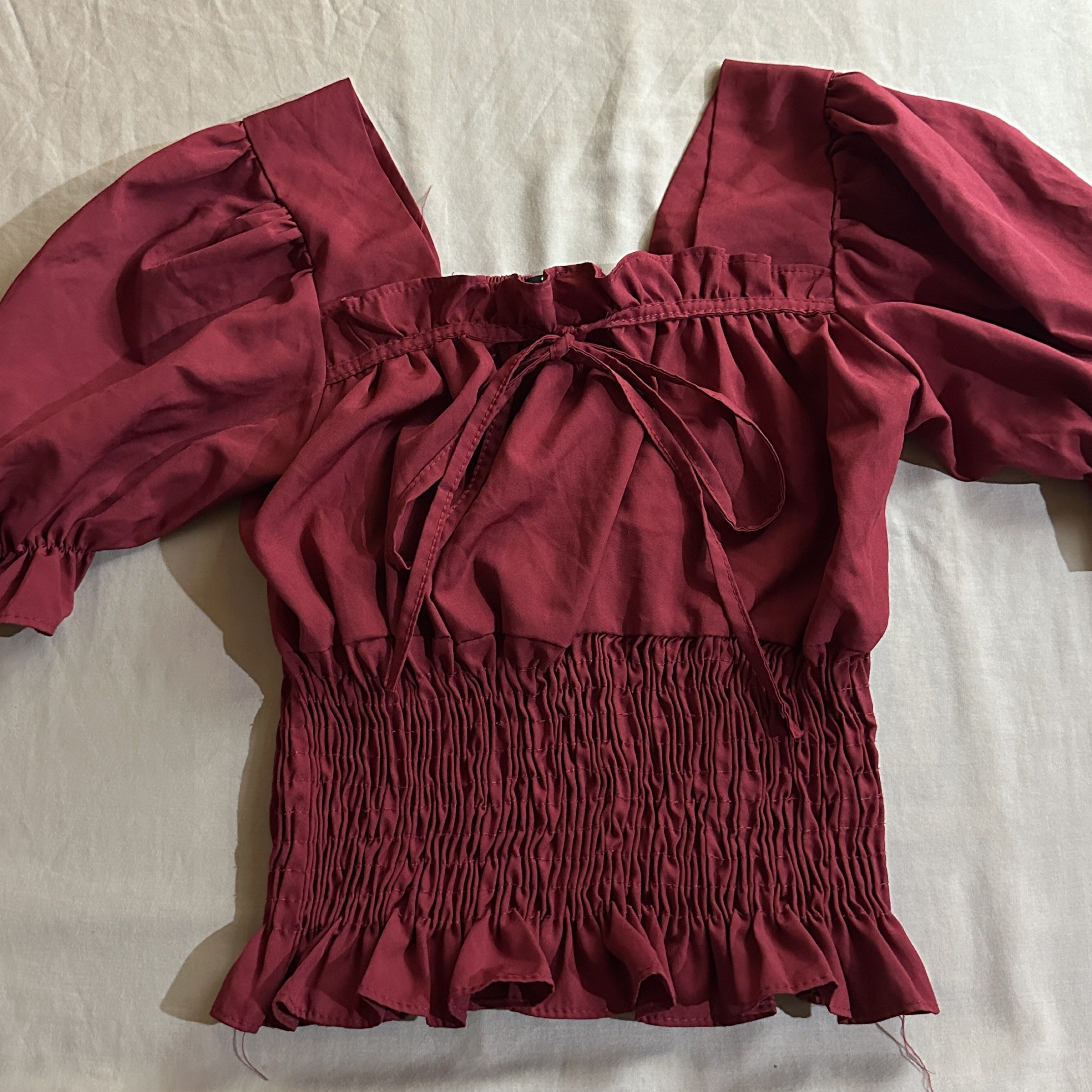 Square Neck Puff Sleeve Blouse (Category: Blouses) located in Baguio. Submitted by chaewos (Listing ID 1418127334, Image 1). Description: - Burgundy blouse - Square neckline - Puff sleeves (3/4 length) - Tie detail at front - Ruffled hem 2 for ₱80.