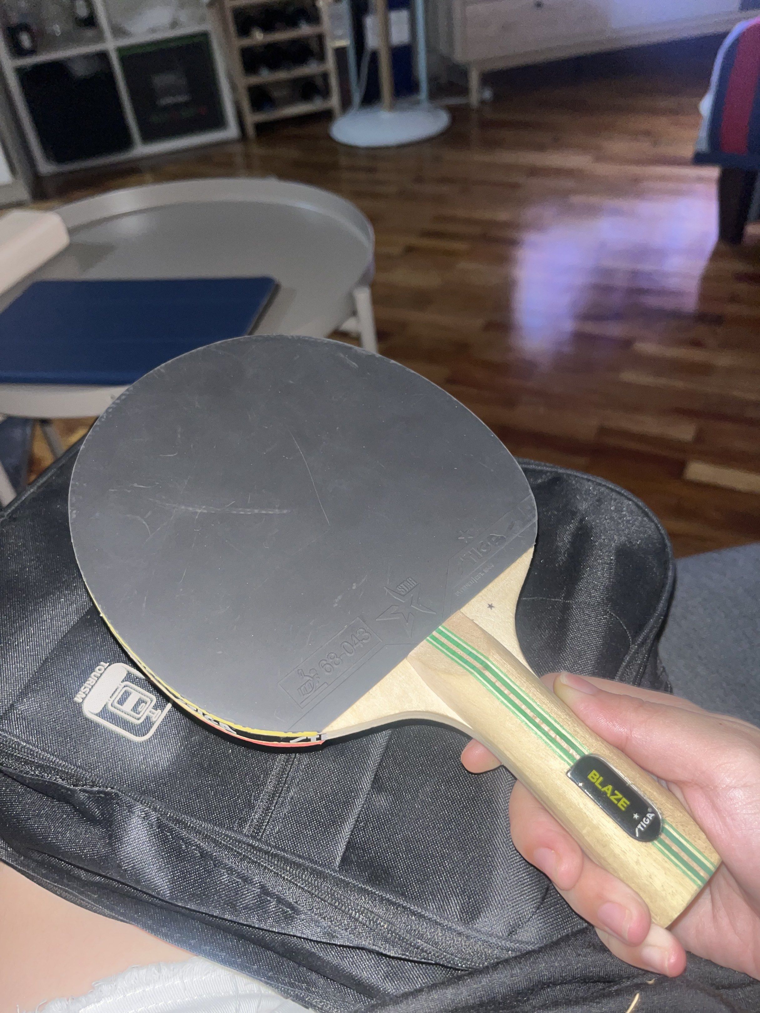 Stiga Blaze Table Tennis Racket and Balls (Category: Racket and Ball Sports) located in Batangas. Submitted by ari252525 (Listing ID 1418138221, Image 2). Description: - Stiga Blaze table tennis racket - Red rubber on one side, black on the other - Green striped handle - Includes two Toby's 40+ table tennis balls - White balls with Toby's logo - Perfect for casual play and practice.