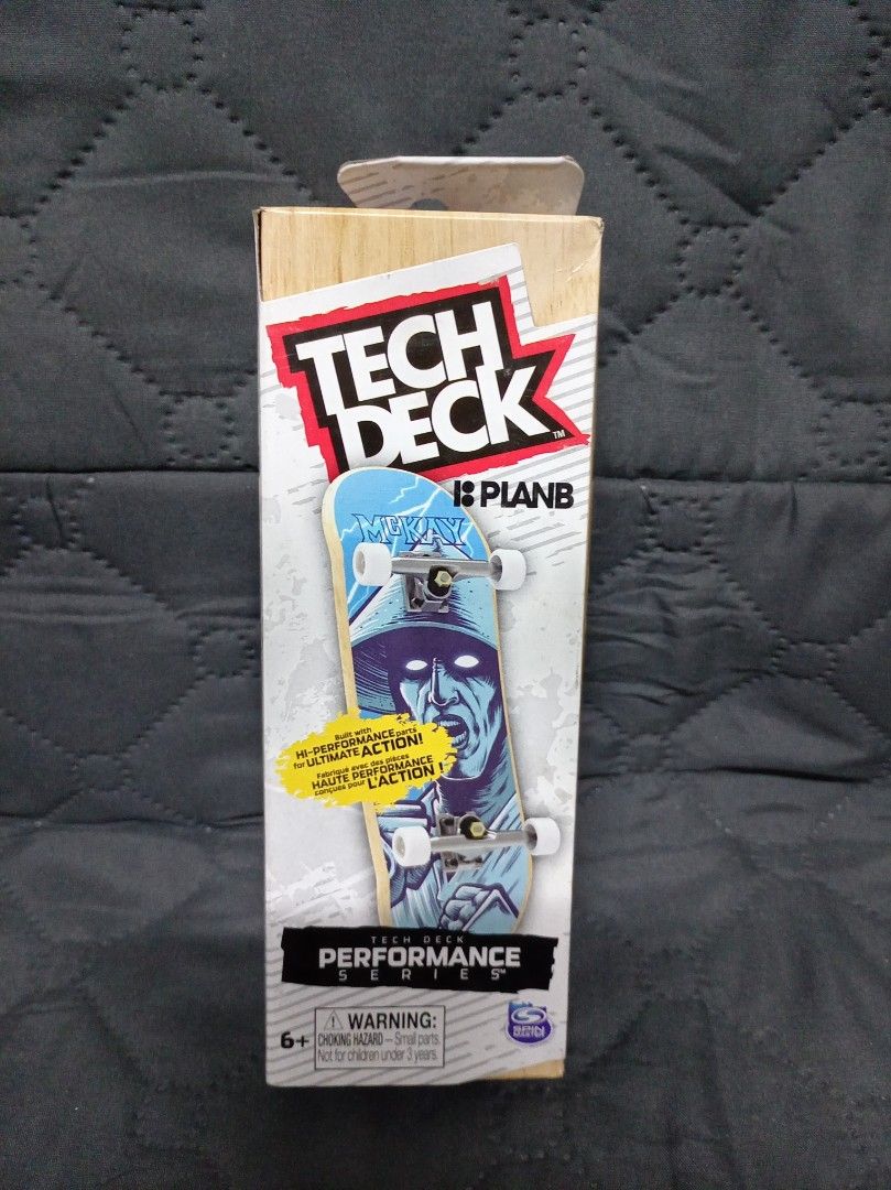 Tech Deck Plan B Fingerboard (Category: Action & Battle Toys) located in Cainta. Submitted by miggysabalboro1571 (Listing ID 1418081978, Image 2). Description: Tech Deck fingerboard features a Plan B design. It has a real wood board, foam grip tape, soft durometer grippy wheels, and rubber bushings. The fingerboard is part of the Performance Series and is suitable for ages 6+. The box shows the fingerboard's design and features..