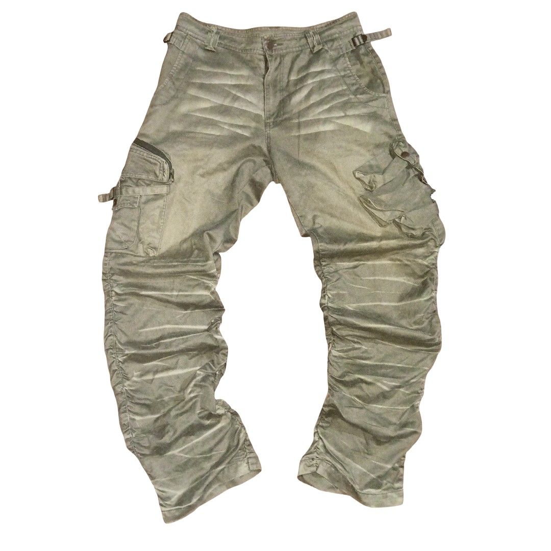Two Persons Homme Multipocket Pants (Category: Jeans) located in Manila. Submitted by c4pybr (Listing ID 1418132445, Image 1). Description: Rare Two Persons Homme multipocket pants. Features multiple pockets and unique design details. The pants have a distinctive gathered or ruched effect on the lower legs. They have a button and zipper closure. The pants have a light green or khaki color. WAIST - 32 LENGTH - 42.5 LEG OPENING - 9 SLIGHTLY NEGO DM
