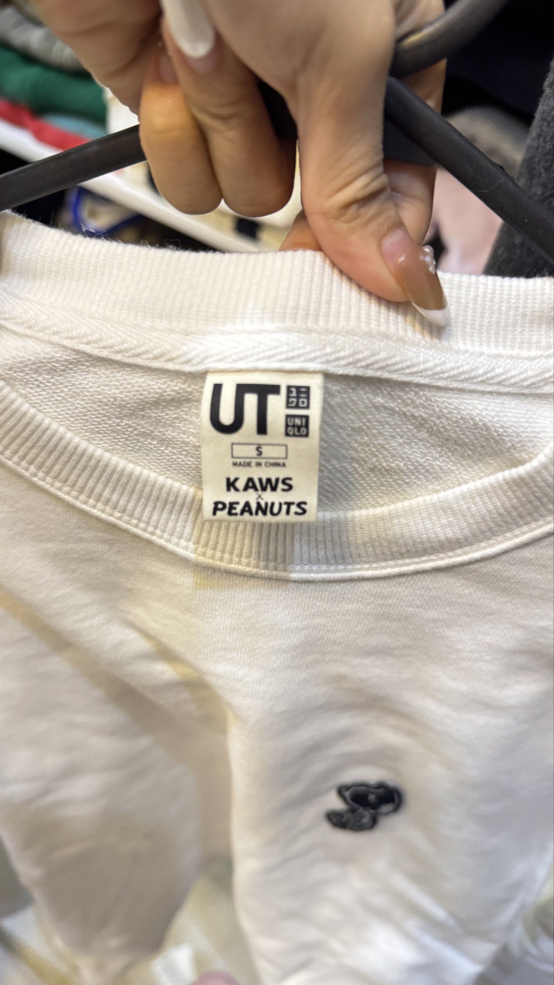 Uniqlo UT KAWS Peanuts Sweatshirt (Category: Coats, Jackets and Outerwear) located in Mandaluyong City. Submitted by prelovedcole (Listing ID 1418148020, Image 3). Description: Uniqlo UT KAWS Peanuts sweatshirt. Size S. Made in China. Crew neck, long sleeves. Small embroidered front design..