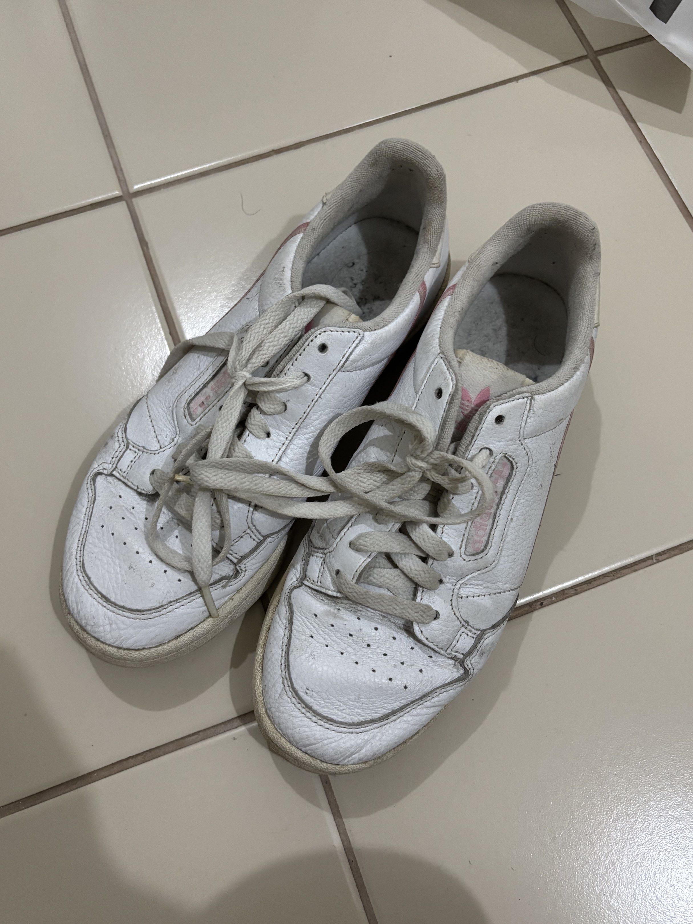 Adidas Continental 80s White Sneakers (Category: Sneakers) located in Pasig City. Submitted by sarpaz (Listing ID 1418264582, Image 1). Description: - Adidas Continental 80s - White colorway - Pink side accent - Signs of wear on leather and soles - Some dirt on inner lining - Laces tied together US WOMEN 8.5.
