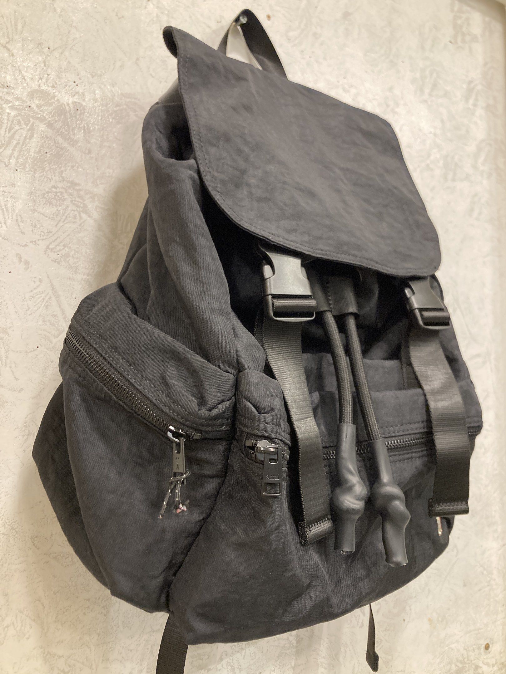 AMI Alexandre Mattiussi Backpack (Category: Luxury Bags & Wallets) located in Quezon City. Submitted by janisu0303 (Listing ID 1418393543, Image 3). Description: - Black AMI Alexandre Mattiussi backpack - Flap closure with buckle straps - Front zip pocket - Side pockets - AMI logo on front - Top handle - Adjustable shoulder straps - Mesh lining inside - Brand label inside 7500 php Good Condition Fairview Area meetups Or shipping .