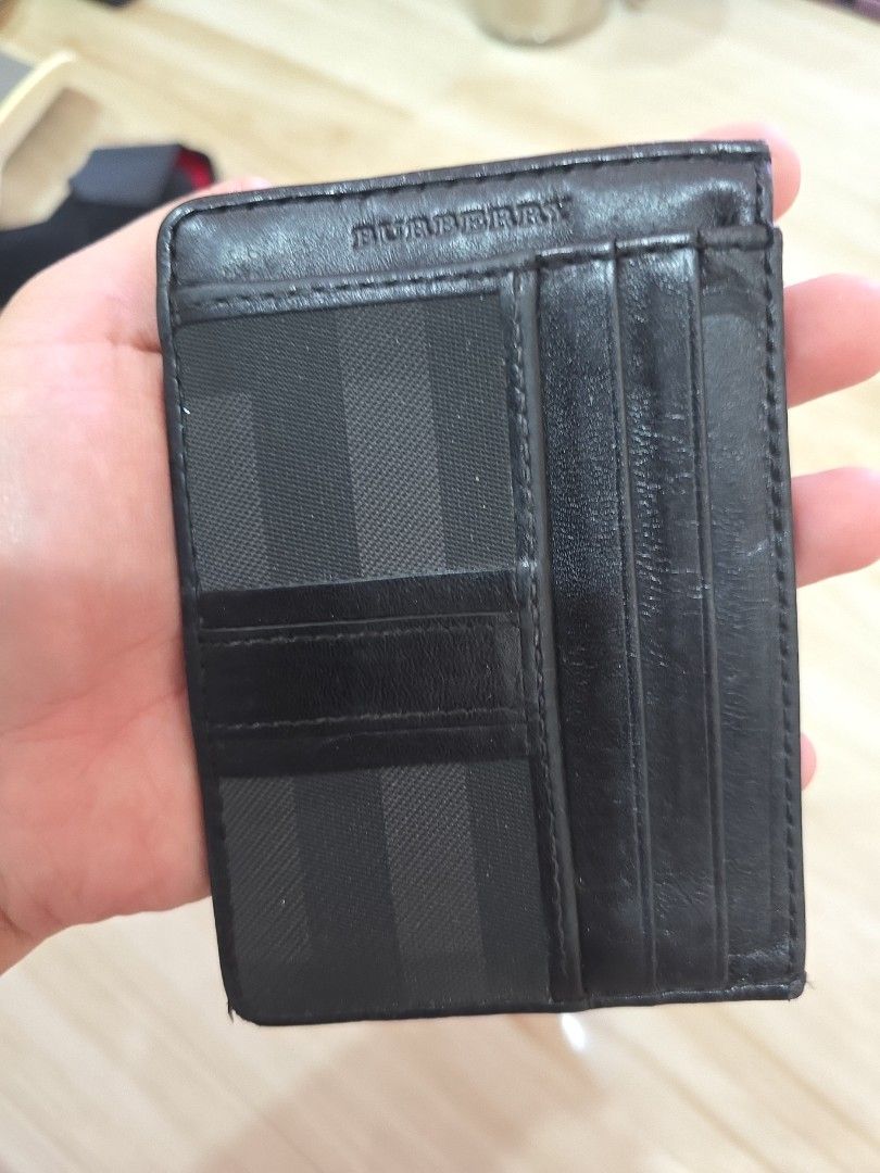 Authentic Burberry Black Card Holder Wallet (Category: Luxury Bags & Wallets) located in Manila. Submitted by dikonaneed (Listing ID 1418295721, Image 2). Description: very spacious can fit 10-12 cards cards with flaw on one corner but if you bring to leather repair store can be easily fixed needs cleaning as well but still usable .