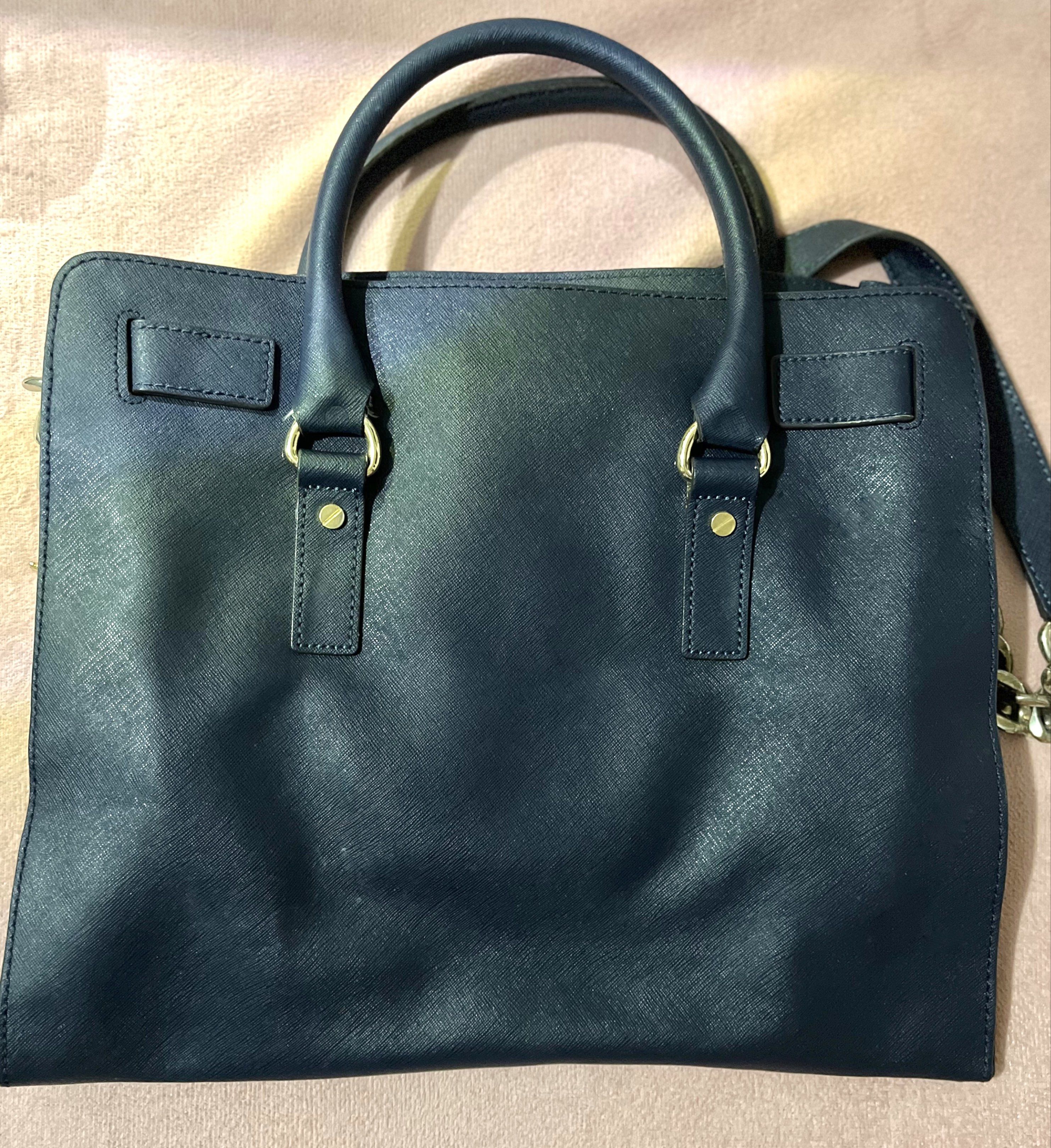 Authentic Michael Kors Large Hamilton Satchel Bag (Category: Luxury Bags & Wallets) located in Manila. Submitted by sophie.navs (Listing ID 1418375605, Image 2). Description: MICHAEL Michael Kors Large Hamilton bag in navy blue saffiano leather with gold-tone hardware. - Authentic Michael Kors Hamilton satchel - Color: Navy blue - Front flap with lock closure - Key charm - Gold-tone hardware - Spacious size — perfect for travel or daily carry if 