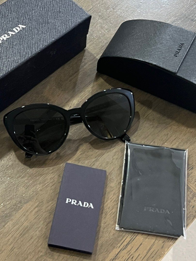 Authentic Prada Sunglasses (Category: Sunglasses & Eyewear) located in Pasay City. Submitted by declutterwyza (Listing ID 1418302908, Image 1). Description: Bought in HK, authentic Prada sunglasses. Comes with: - Prada case - Unopened Prada cleaning cloth - Prada box.