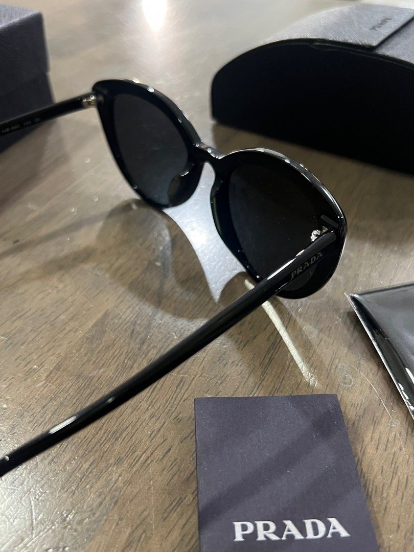 Authentic Prada Sunglasses (Category: Sunglasses & Eyewear) located in Pasay City. Submitted by declutterwyza (Listing ID 1418302908, Image 3). Description: Bought in HK, authentic Prada sunglasses. Comes with: - Prada case - Unopened Prada cleaning cloth - Prada box.
