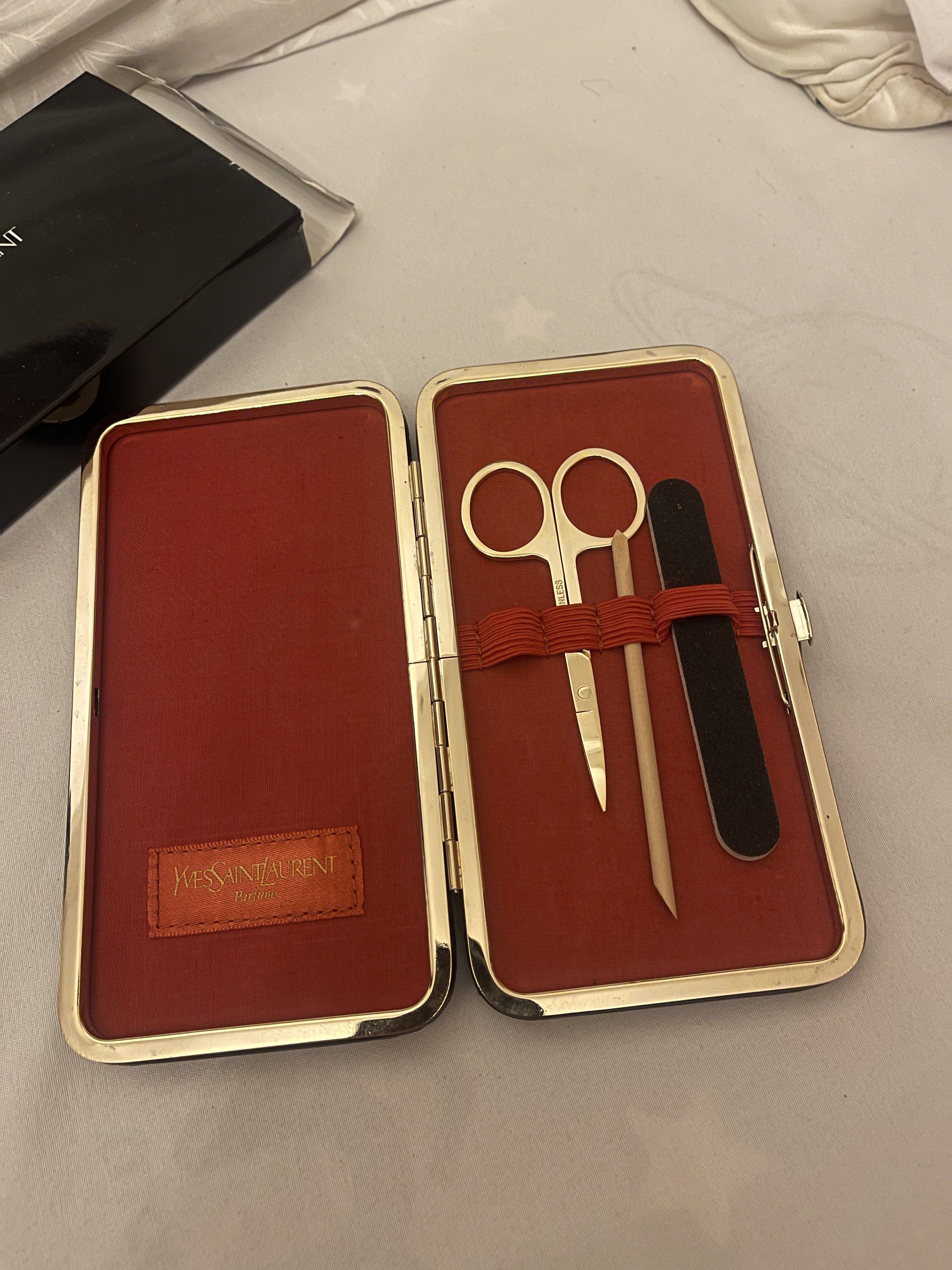 Authentic Yves Saint Laurent Parfums Manicure Kit (Category: Cases & Sleeves) located in Marilao. Submitted by wardrovearchives (Listing ID 1418362942, Image 2). Description: Authentic Yves Saint Laurent Parfums Manicure Kit Authentic vintage Yves Saint Laurent Parfums manicure kit from the YSL Beauté line. Classic glossy black hard case with embossed YSL logo and elegant red interior. Includes: • Stainless steel scissors • Nail file • Cuticle pu