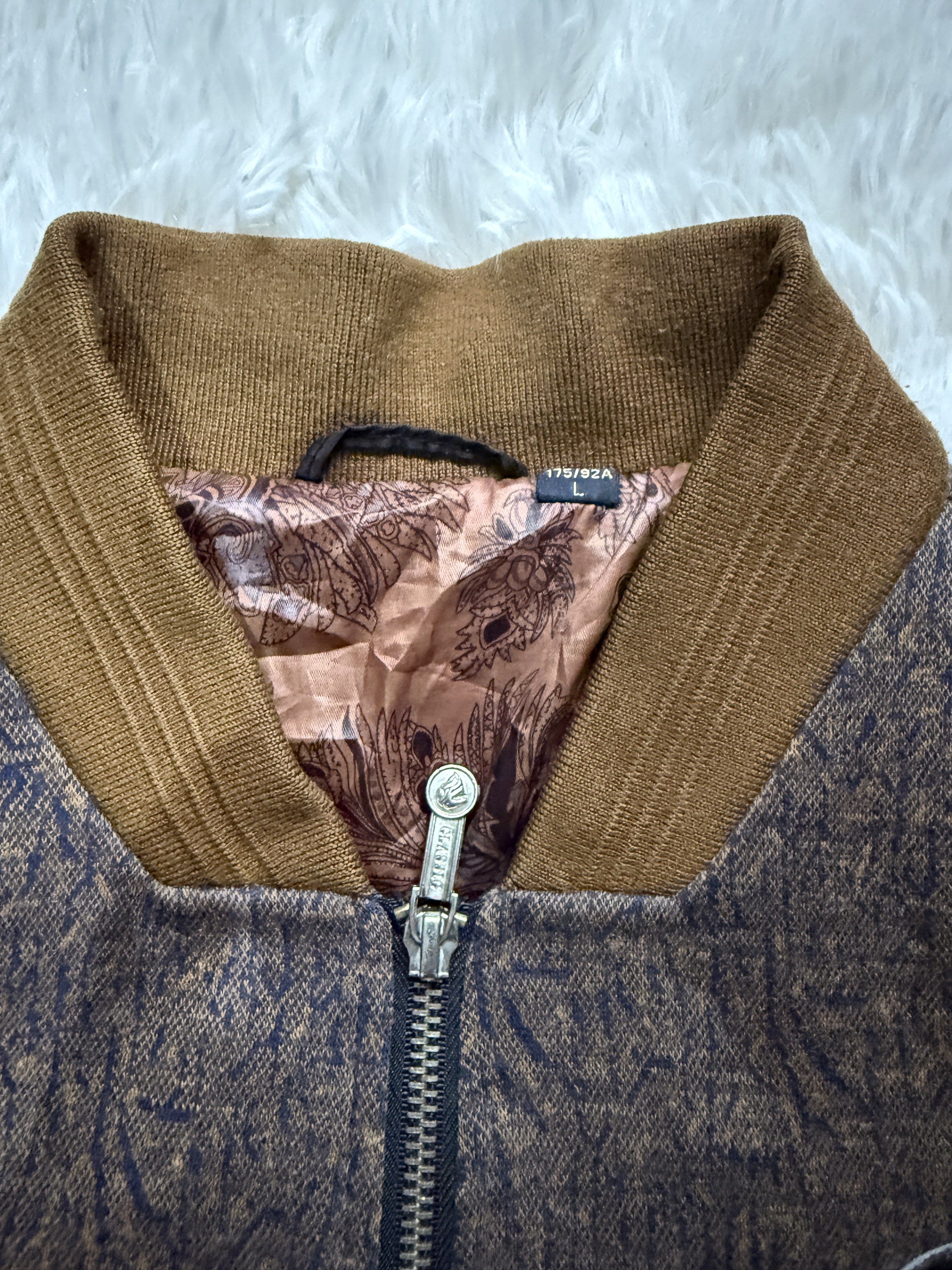 Bomber Jacket with Patch (Category: Coats, Jackets and Outerwear) located in Manila. Submitted by keepercollection (Listing ID 1418209909, Image 3). Description: - Stylish bomber jacket - Unique patterned design - Brown sleeves and collar - Full zipper closure - Two front pockets - Decorative chest patch - Paisley-patterned lining - Size: L.