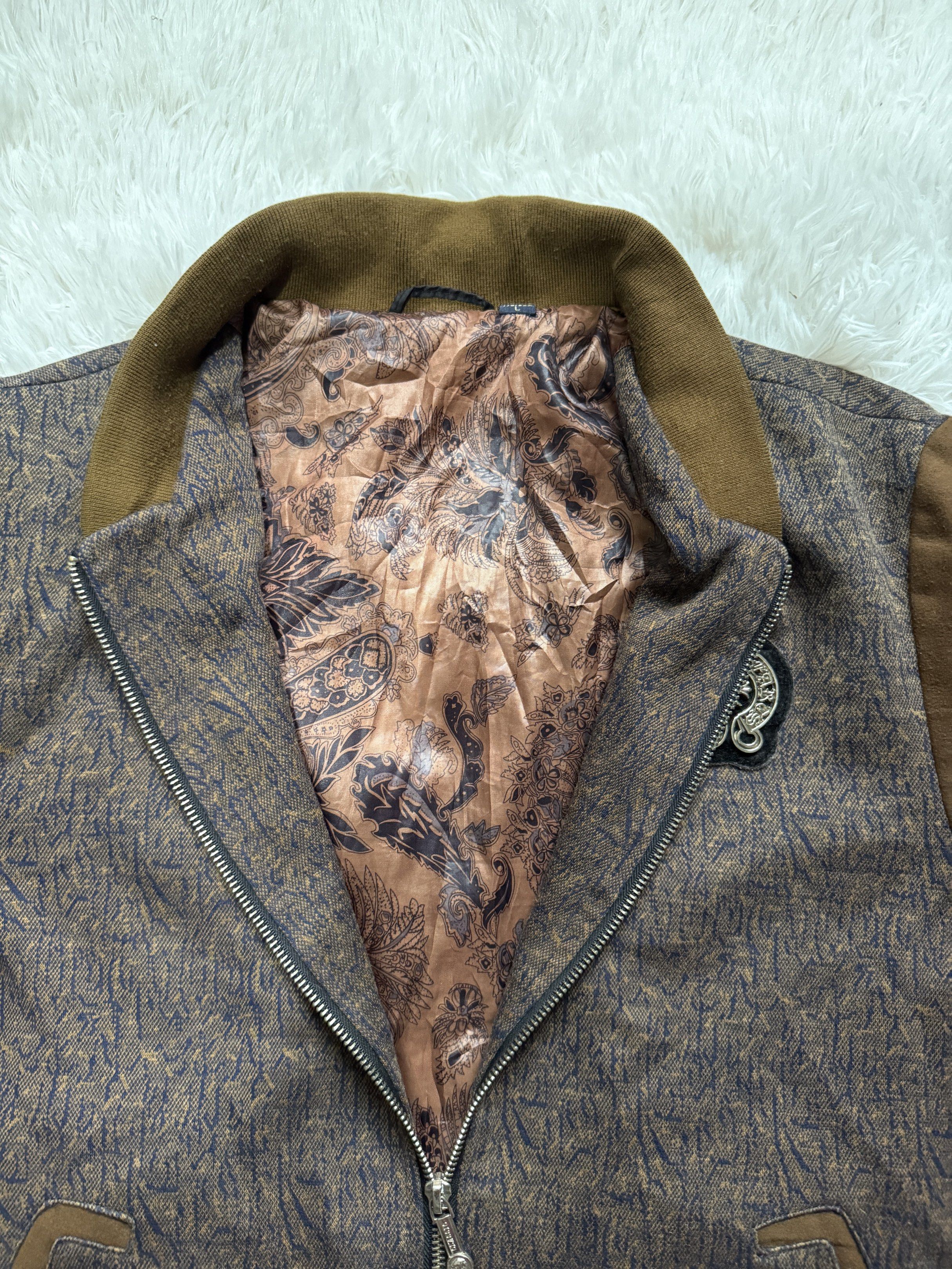 Bomber Jacket with Patch (Category: Coats, Jackets and Outerwear) located in Manila. Submitted by keepercollection (Listing ID 1418209909, Image 2). Description: - Stylish bomber jacket - Unique patterned design - Brown sleeves and collar - Full zipper closure - Two front pockets - Decorative chest patch - Paisley-patterned lining - Size: L.