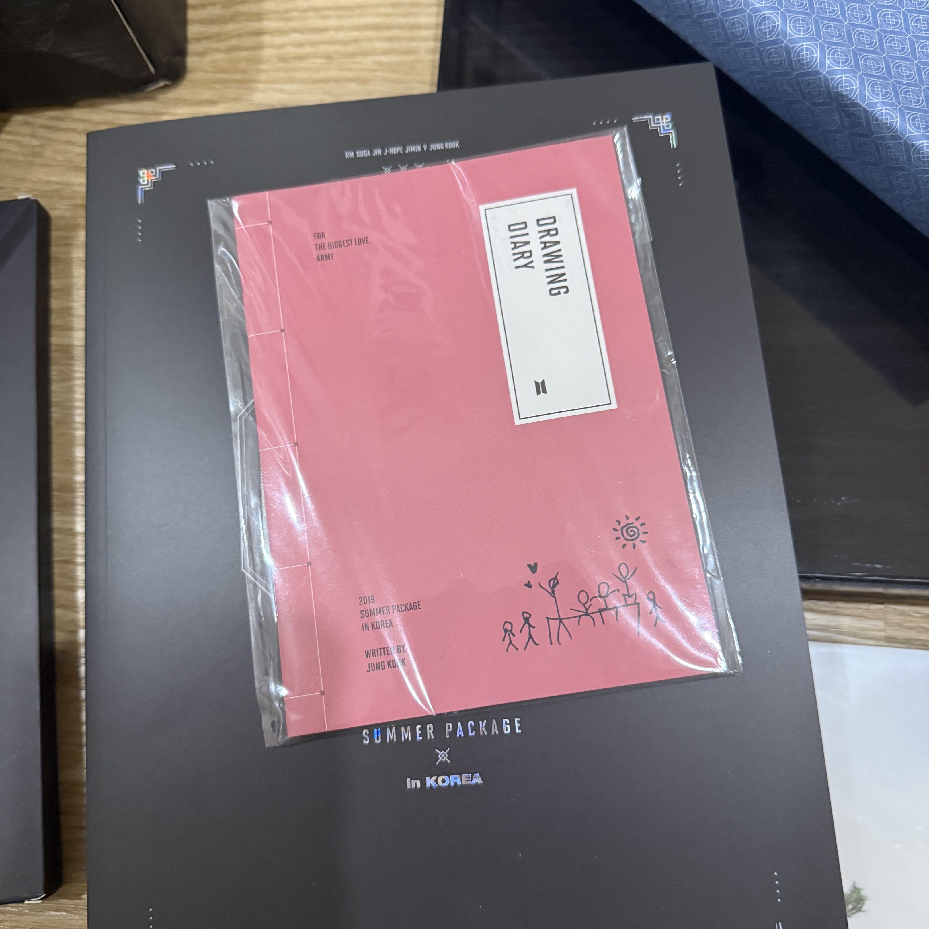 BTS 2019 Summer Package in Korea with Jungkook Diary (Category: K-Wave Merchandise) located in Cainta. Submitted by ac.decluttering (Listing ID 1418392005, Image 2). Description: BTS 2019 Summer Package in Korea with Jungkook Drawing Book - complete inclusions (outer box, acrylic case drawing diary, photobook, dvd, fan, folding screen, poster, mini poster) - unsealed - in good condition except for the outer box cause the material is hard to maint