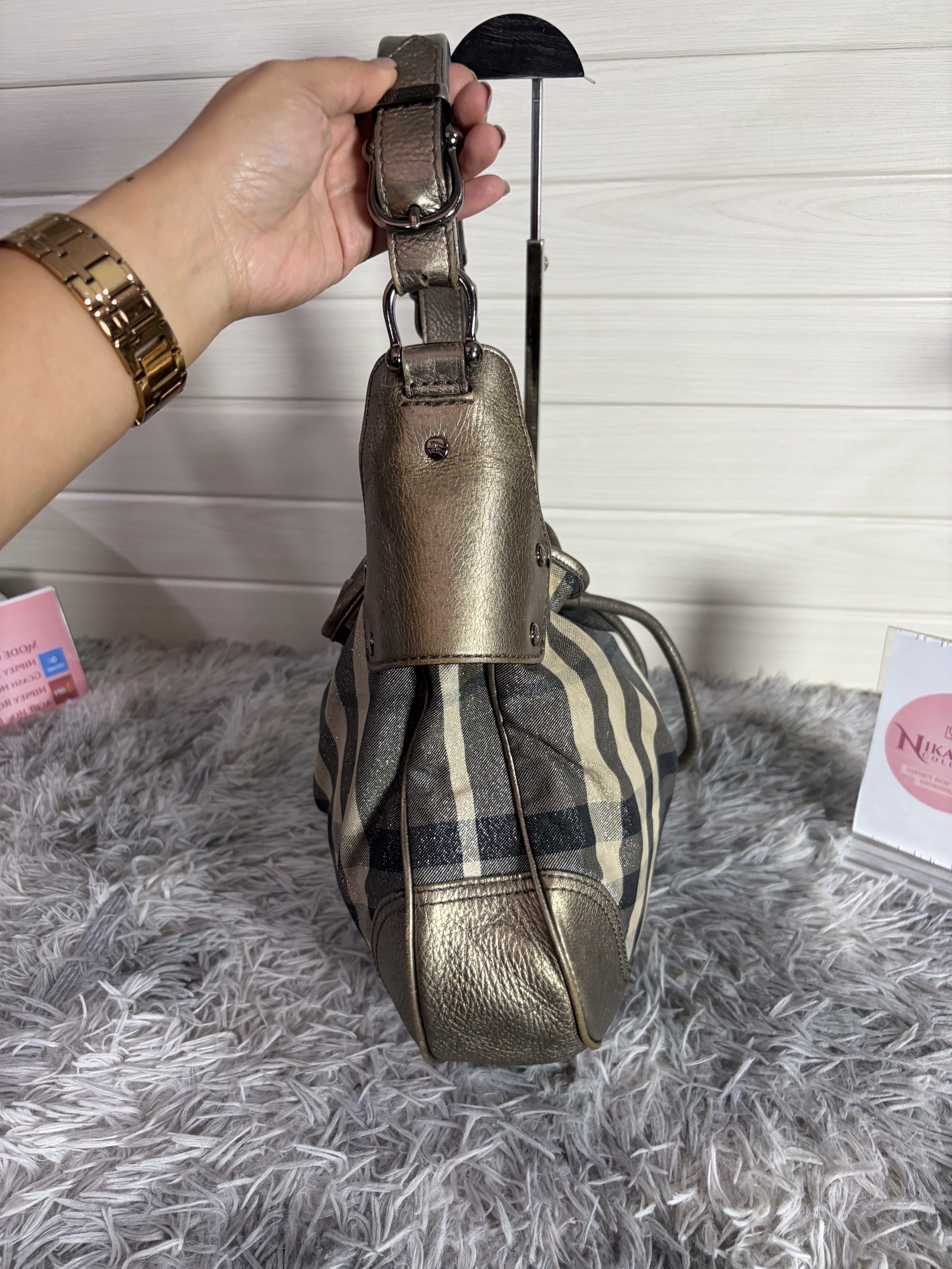 Burberry Hobo Bag (Category: Luxury Bags & Wallets) located in Malvar. Submitted by nikaellascollection_0923 (Listing ID 1418249407, Image 3). Description: - Authentic Burberry hobo bag - Classic check pattern - Drawstring closure - Metallic leather trim - Interior zippered pocket - Comfortable shoulder strap - Stylish design - Perfect for everyday use.