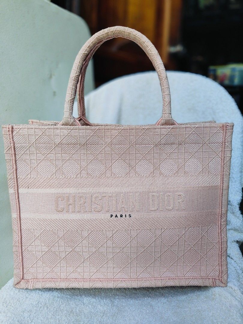 Christian Dior Book Tote Bag (Category: Luxury Bags & Wallets) located in Cebu City. Submitted by cherreymie70208 (Listing ID 1418240636, Image 1). Description: - Christian Dior Book Tote Bag - Lovely pink color - Features the Christian Dior logo - Made in Italy - Spacious interior - Unique textured exterior - Two top handles.