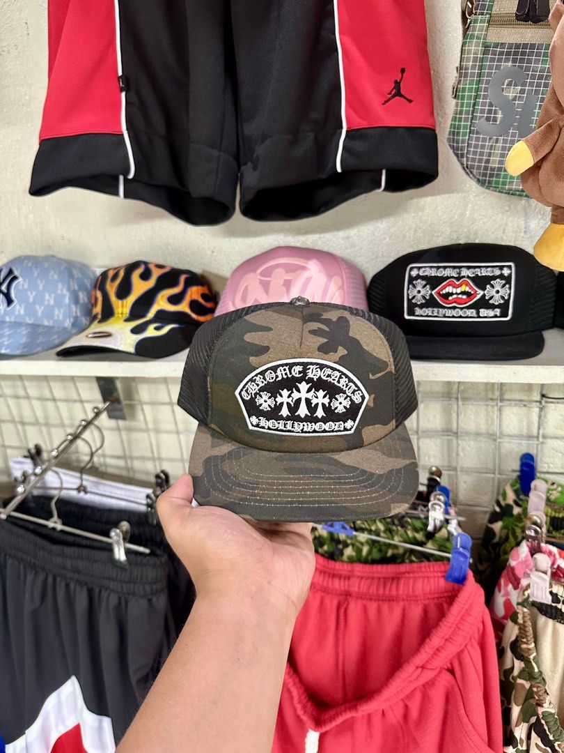 Chrome Hearts Hollywood Camo Cap (Category: Caps & Hats) located in Cavite. Submitted by teamhd (Listing ID 1418289201, Image 1). Description: - Chrome Hearts Cap - Camouflage pattern with black mesh - Features Chrome Hearts Hollywood logo patch - Flat brim - Snapback closure - Also available: Pink brim cap with white patch.