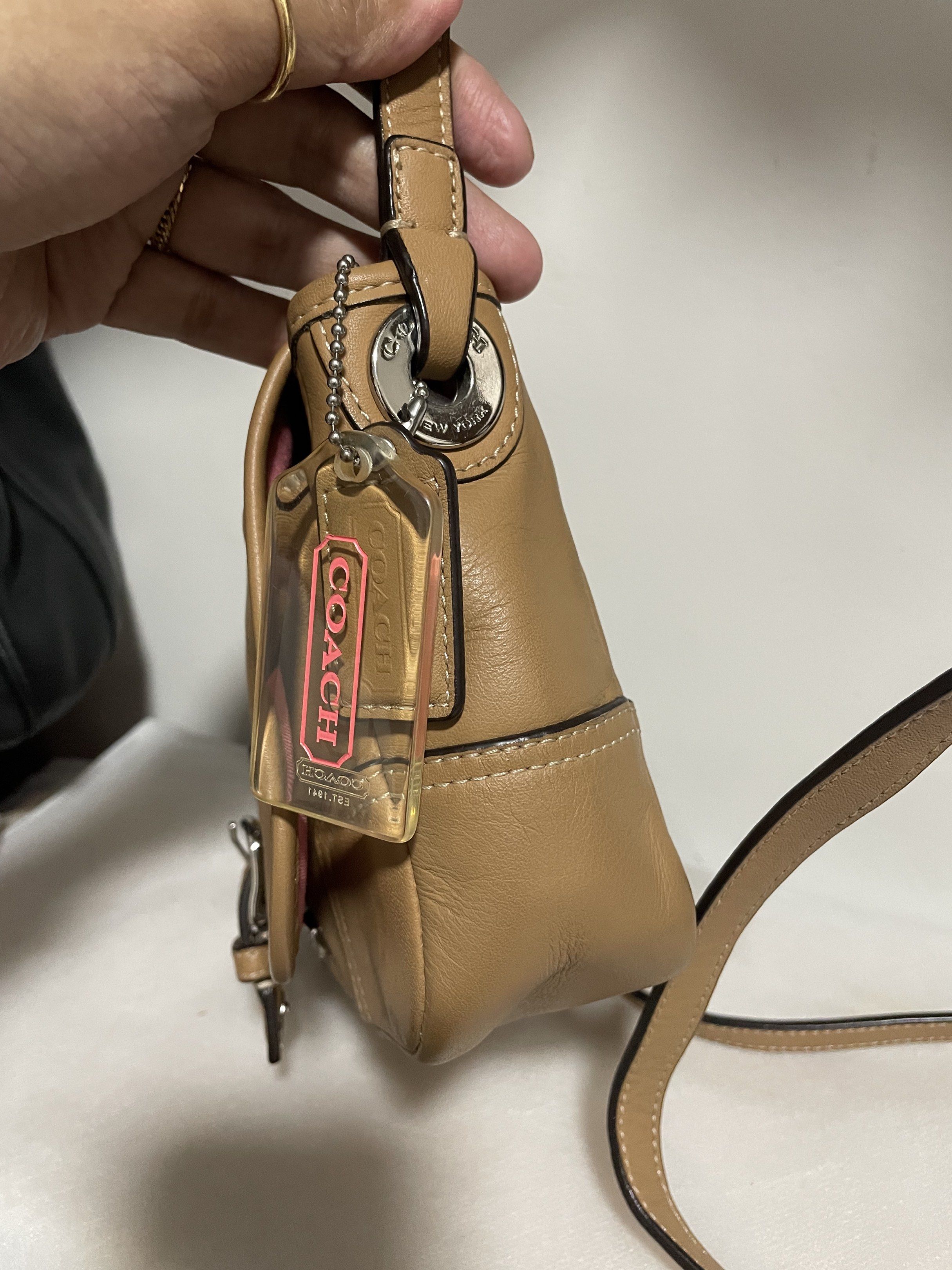 Coach Hadley Leather Field Shoulder Bag (Category: Luxury Bags & Wallets) located in Guiguinto. Submitted by prelovedinc2024 (Listing ID 1418376259, Image 3). Description: guaranteed authentic, bought in Japan with signs of use - creases, rubs on corners, some dirt on zip pocket silver hardwares - no tarnish but with hairlines very clean inside last photo is only for reference size: 8x5.5x2” - Coach Hadley shoulder bag - Camel color - Flap closur