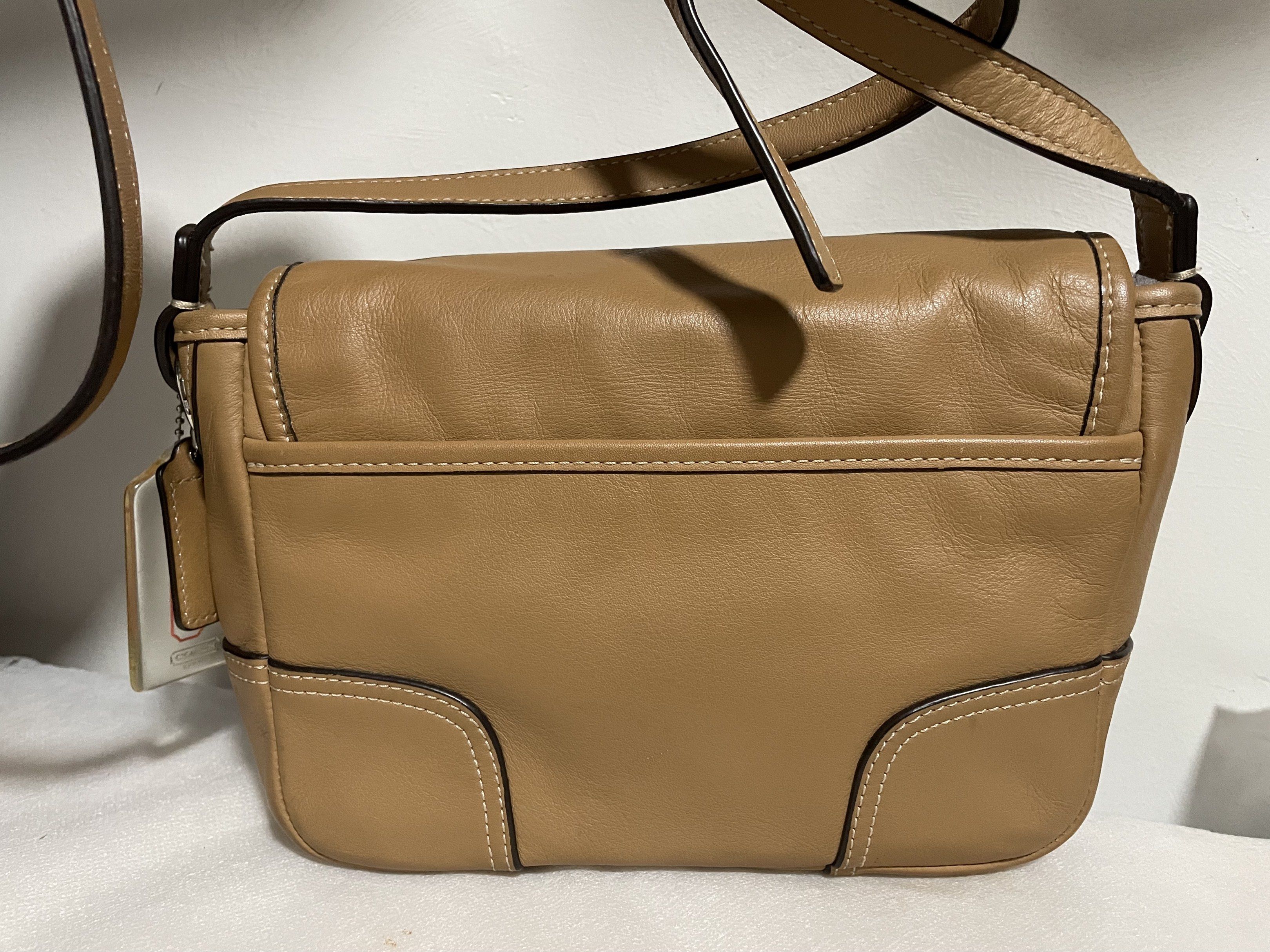Coach Hadley Leather Field Shoulder Bag (Category: Luxury Bags & Wallets) located in Guiguinto. Submitted by prelovedinc2024 (Listing ID 1418376259, Image 2). Description: guaranteed authentic, bought in Japan with signs of use - creases, rubs on corners, some dirt on zip pocket silver hardwares - no tarnish but with hairlines very clean inside last photo is only for reference size: 8x5.5x2” - Coach Hadley shoulder bag - Camel color - Flap closur