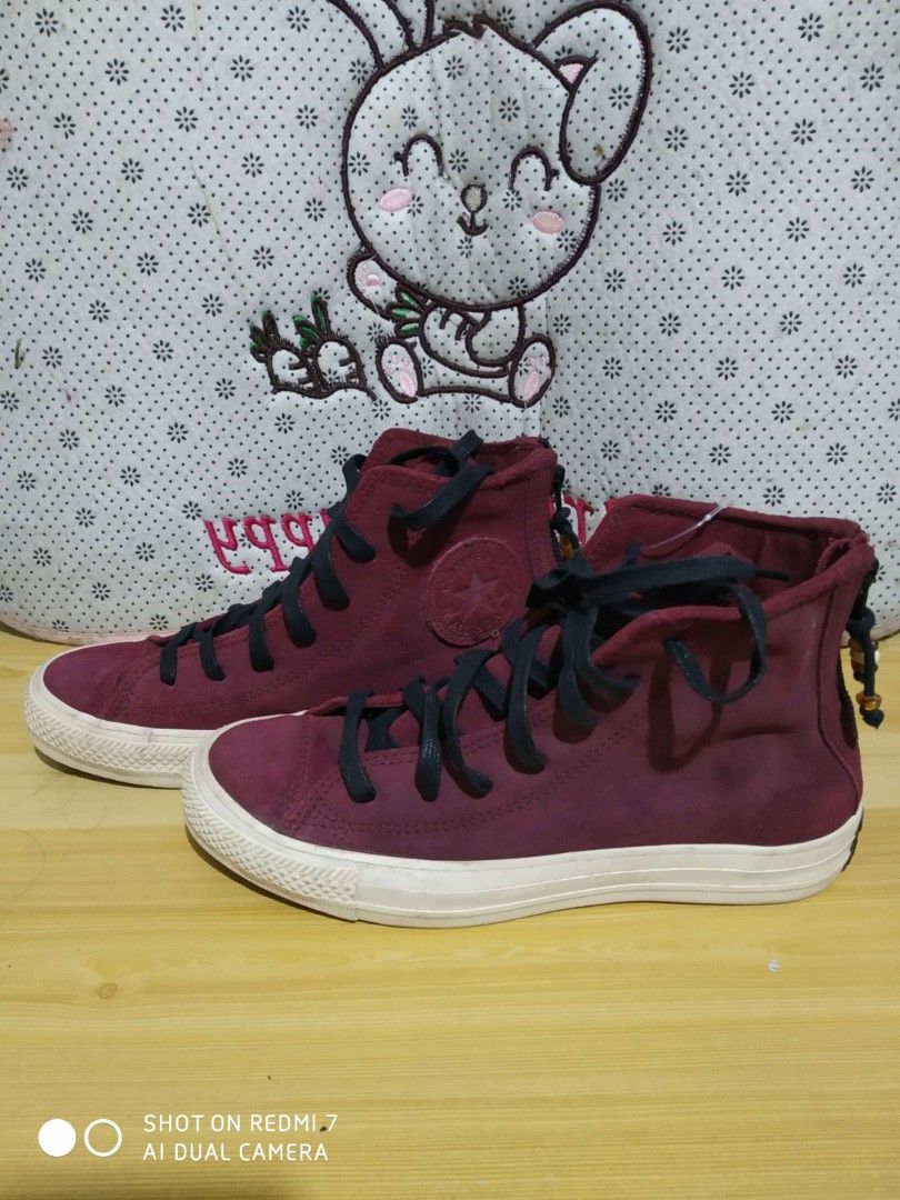 Converse Chuck Taylor All Star High Top Sneakers (Category: Sneakers) located in Manila. Submitted by cyj08 (Listing ID 1418276809, Image 2). Description: - Maroon Converse Chuck Taylor All Star high-top sneakers - High-top design - Black laces - White sole - Converse logo on the side - Suede-like texture - Zipper detail at the back.