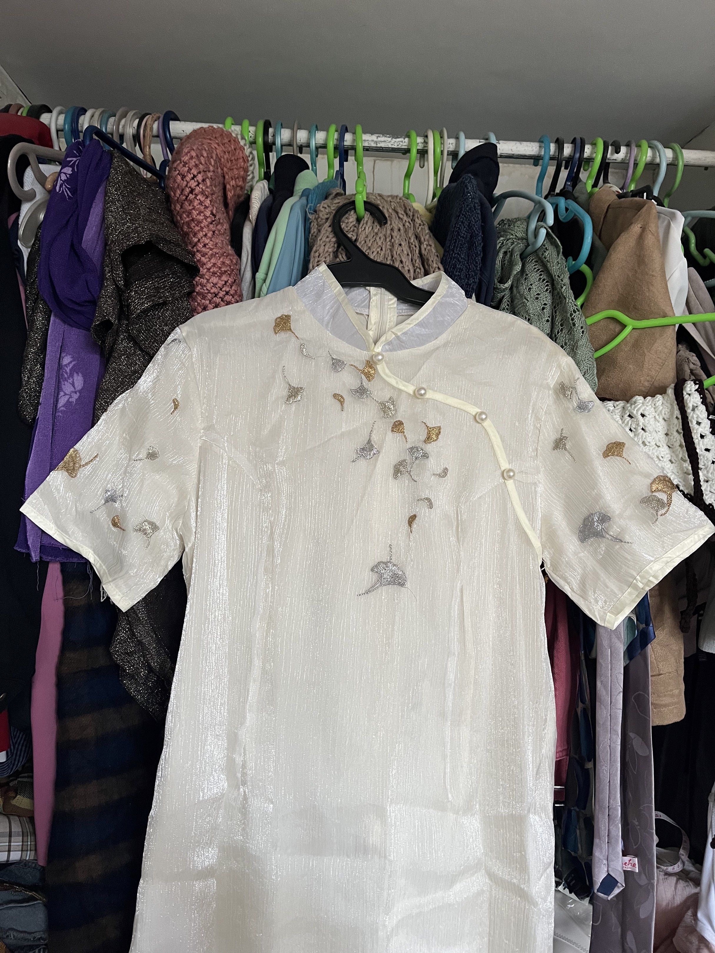 Embroidered Cheongsam Dress (Category: Dresses) located in Quezon City. Submitted by mel.highmoons (Listing ID 1418286420, Image 2). Description: Sobrang ganda! For small to semi large. Measurement in inches (laid flat): 17 waist 17 bust 43 length MOP: Gcash/BPI/Bank Transfer MOD: Lalamove, Flash Express Shipping fee to be shouldered by buyer. - Cream-colored cheongsam dress, Delicate embroidery with silver and gold accents, Mandarin collar, Pear