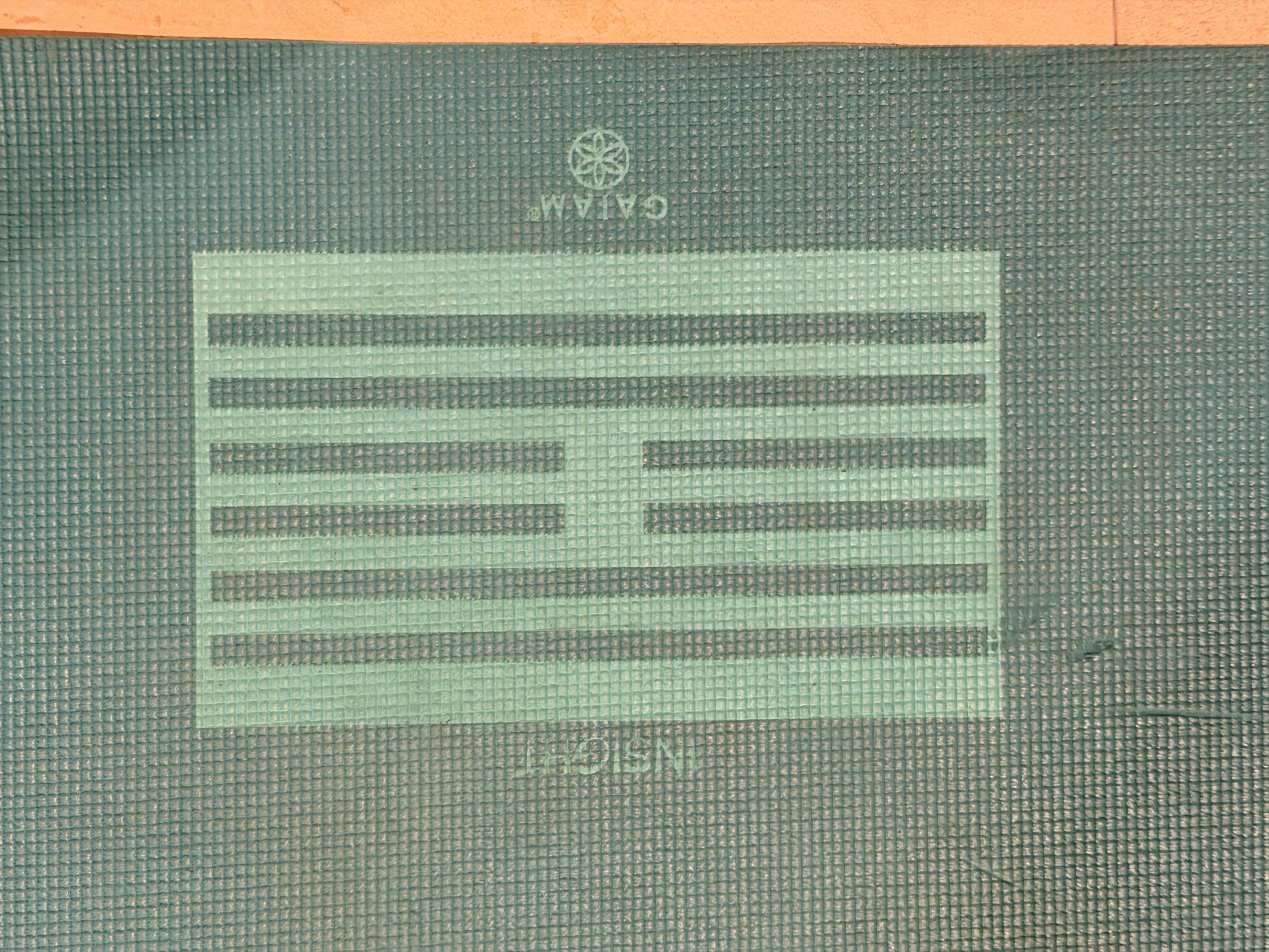 Gaiam Yoga Mat (Category: Exercise Mats) located in Manila. Submitted by jana_5678 (Listing ID 1418359634, Image 2). Description: - Gaiam yoga mat - Teal color - Features a geometric design with the word "Insight" - Suitable for yoga and floor exercises - Provides a comfortable and supportive surface.
