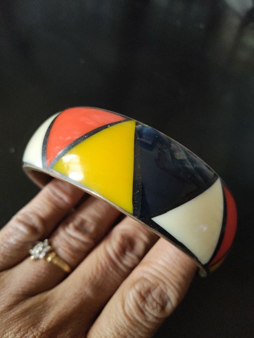 Geometric Pattern Bangle (Category: Bracelets) located in Seri Kembangan. Submitted by raennjaafar (Listing ID 1418221243, Image 3). Description: - Eye-catching bangle with a colorful geometric design. - Colors: Red, yellow, white, and navy blue. - Brass Inlaid band(light weight) - Approximate inner diameter: 10cm. - Perfect accessory to brighten up your look!.