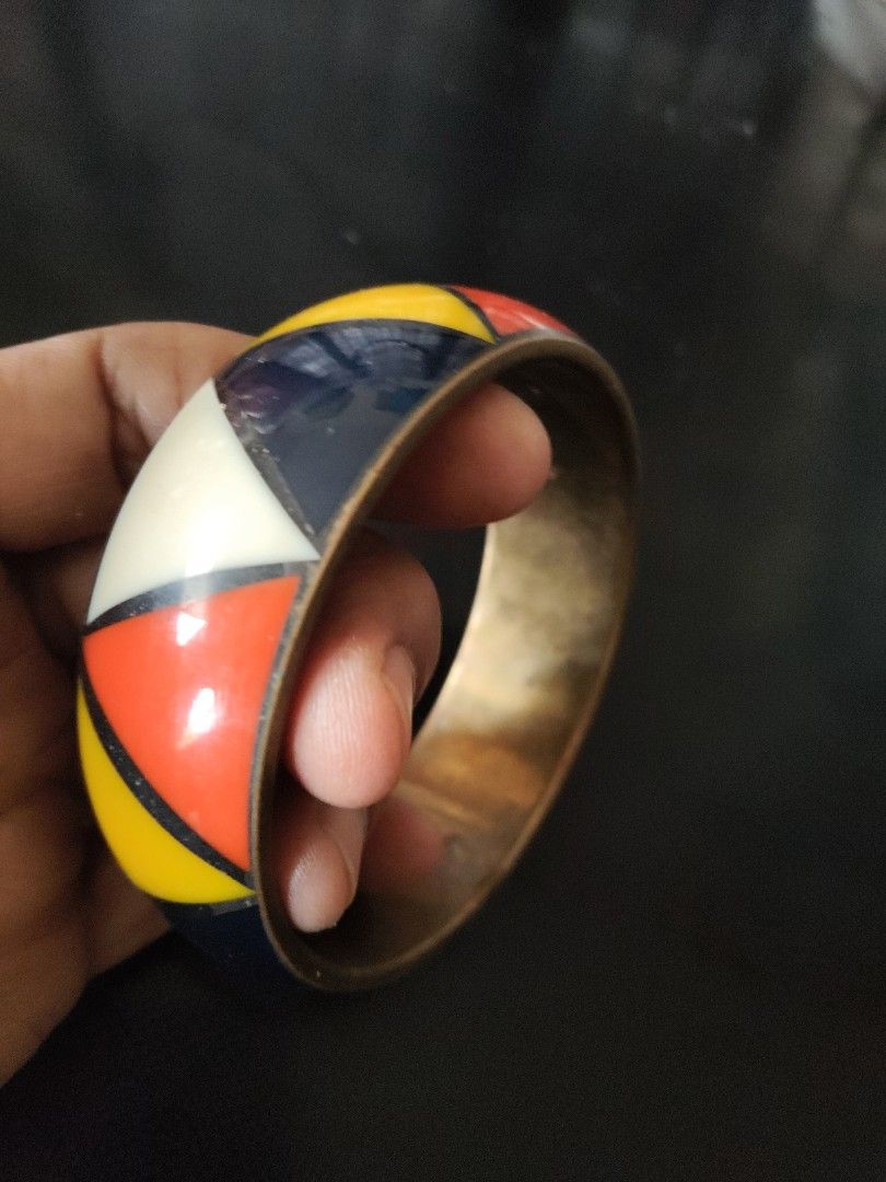 Geometric Pattern Bangle (Category: Bracelets) located in Seri Kembangan. Submitted by raennjaafar (Listing ID 1418221243, Image 1). Description: - Eye-catching bangle with a colorful geometric design. - Colors: Red, yellow, white, and navy blue. - Brass Inlaid band(light weight) - Approximate inner diameter: 10cm. - Perfect accessory to brighten up your look!.
