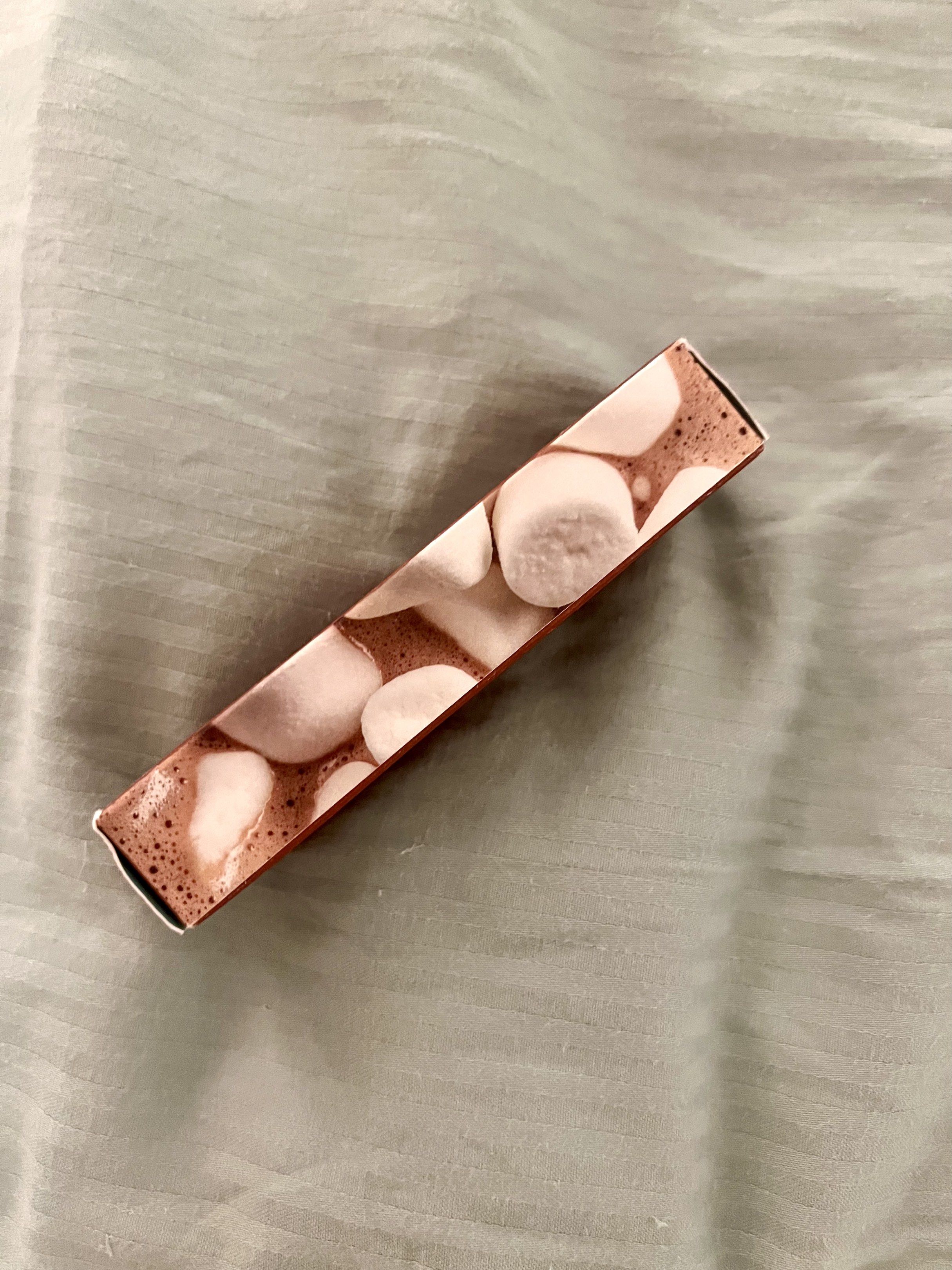 Glossier Hot Cocoa Balm Dotcom (Category: Makeup) located in Taguig. Submitted by new_again_ (Listing ID 1418324867, Image 2). Description: - Glossier Hot Cocoa Balm Dotcom - Scent: Hot Cocoa - Size: 15 ml / 0.5 fl oz - Packaging: Brown box with marshmallow design.