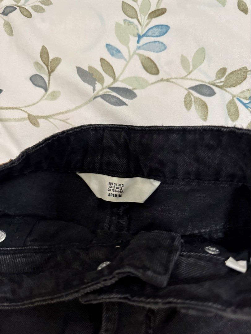 H&M Distressed Black Denim Mini Skirt (Category: Skirts) located in Antipolo. Submitted by nbrns (Listing ID 1418352790, Image 3). Description: - H&M black denim mini skirt - Features a raw hem and distressed details - Includes front and back pockets - Size 34 - Button and zipper closure.