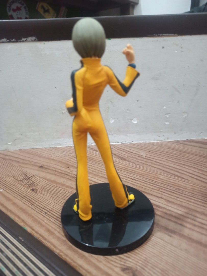Kill Bill The Bride Figurine (Category: Figurines & Statues) located in Manila. Submitted by avrilarqu43176 (Listing ID 1418280805, Image 3). Description: Figurine depicts The Bride from Kill Bill, wearing her iconic yellow jumpsuit. It is mounted on a black circular base. The figure is in a dynamic pose, with one arm raised as if ready to fight. The details of the outfit and the character's face are clearly visible..