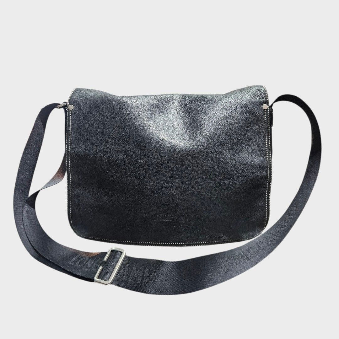 Authentic Longchamp Black Messenger Bag (Category: Luxury Bags & Wallets) located in Baguio. Submitted by second_handchic (Listing ID 1418244650, Image 1). Description: - Authentic Longchamp Messenger Bag - Color: Black - Adjustable shoulder strap - Secure zippered main compartment - Stylish flap closure - Textured exterior - Fabric lining - Features Longchamp logo on strap and zipper pull - Convenient front pocket - Includes Longchamp interior t