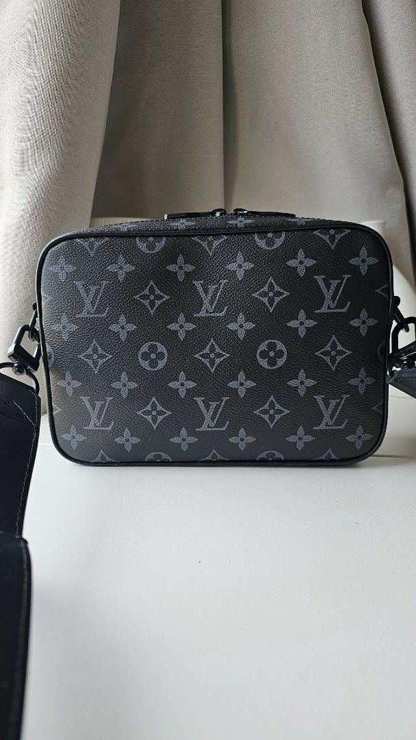 Louis Vuitton Monogram Eclipse Messenger Bag (Category: Luxury Bags & Wallets) located in Caloocan City. Submitted by marie_0812 (Listing ID 1418307835, Image 2). Description: - Louis Vuitton Messenger Bag - Iconic Monogram Eclipse pattern - Adjustable black shoulder strap - Flap closure with chain detail - Zippered main compartment - Interior pocket - Black hardware - Classic LV monogram exterior.