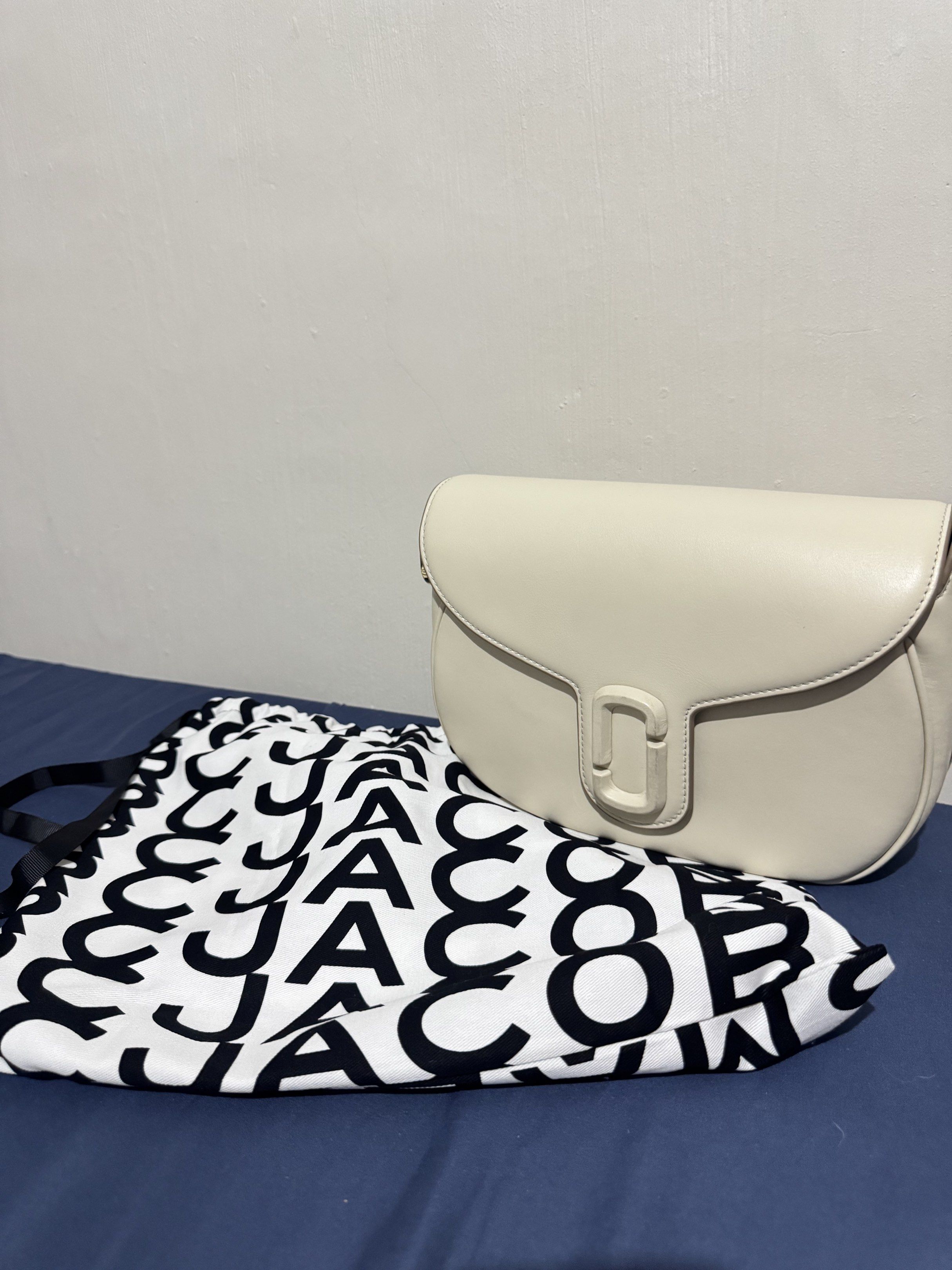 Marc Jacobs Cream Saddle Bag - Large (Category: Luxury Bags & Wallets) located in Imus. Submitted by banessah (Listing ID 1418253008, Image 1). Description: - Cream-colored Marc Jacobs shoulder bag - Made of leather - Flap closure with rectangular buckle - Detachable shoulder strap with logo - Gold-toned hardware USED ONLY3X tag is still inside - Interior zippered pocket - Includes dust bag.