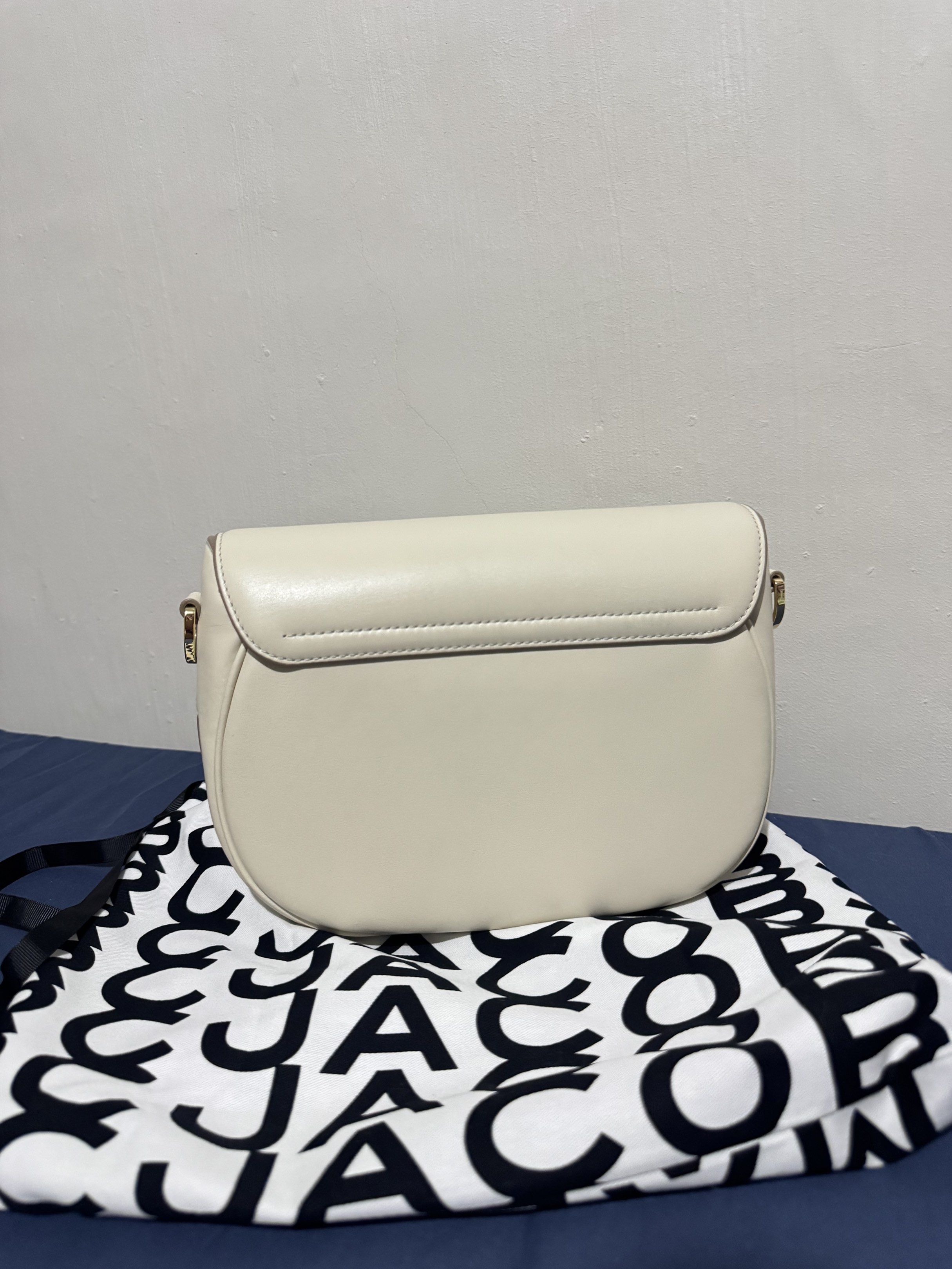 Marc Jacobs Cream Saddle Bag - Large (Category: Luxury Bags & Wallets) located in Imus. Submitted by banessah (Listing ID 1418253008, Image 3). Description: - Cream-colored Marc Jacobs shoulder bag - Made of leather - Flap closure with rectangular buckle - Detachable shoulder strap with logo - Gold-toned hardware USED ONLY3X tag is still inside - Interior zippered pocket - Includes dust bag.