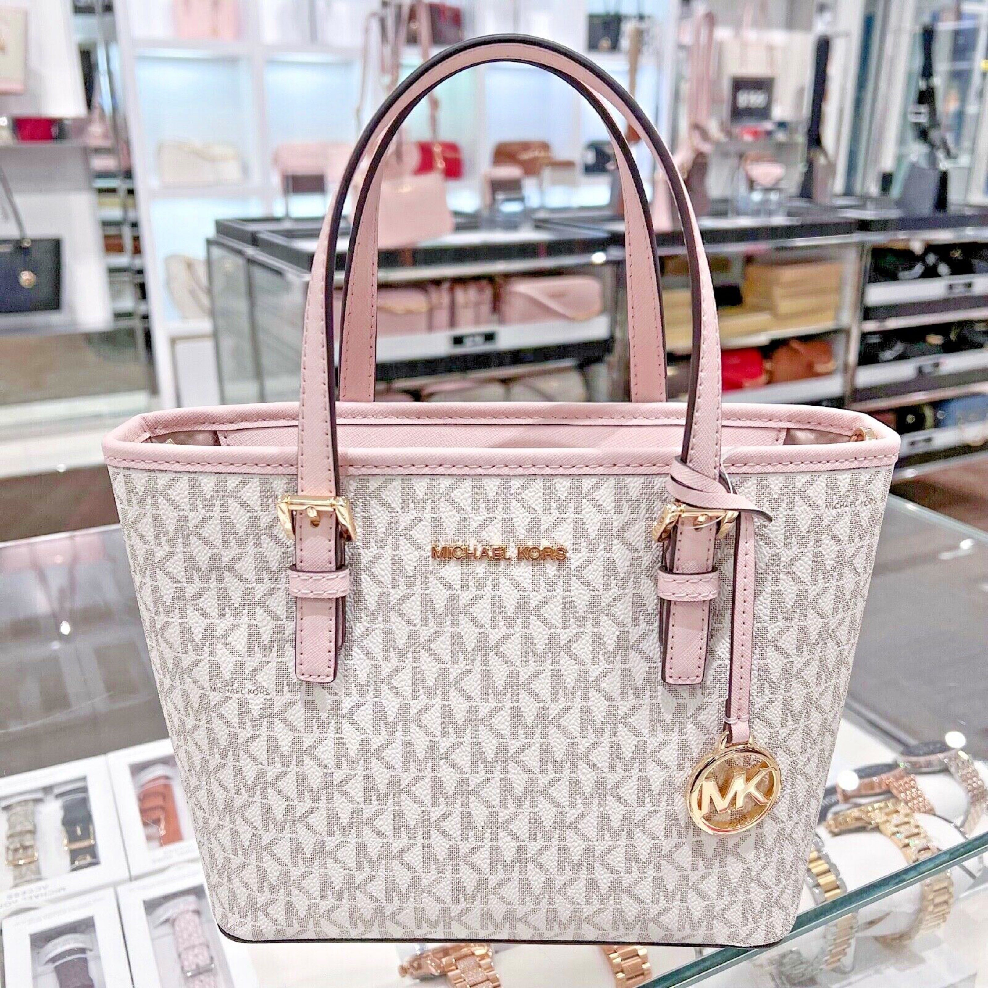 Michael Kors Tote Bag (Category: Luxury Bags & Wallets) located in Padre Garcia. Submitted by riailagan49560 (Listing ID 1418339359, Image 2). Description: - Michael Kors tote bag - Signature MK print - Pink trim and handles - Gold-tone logo charm - Top handle design - Main compartment - Small pocket - Stylish and versatile for everyday use.