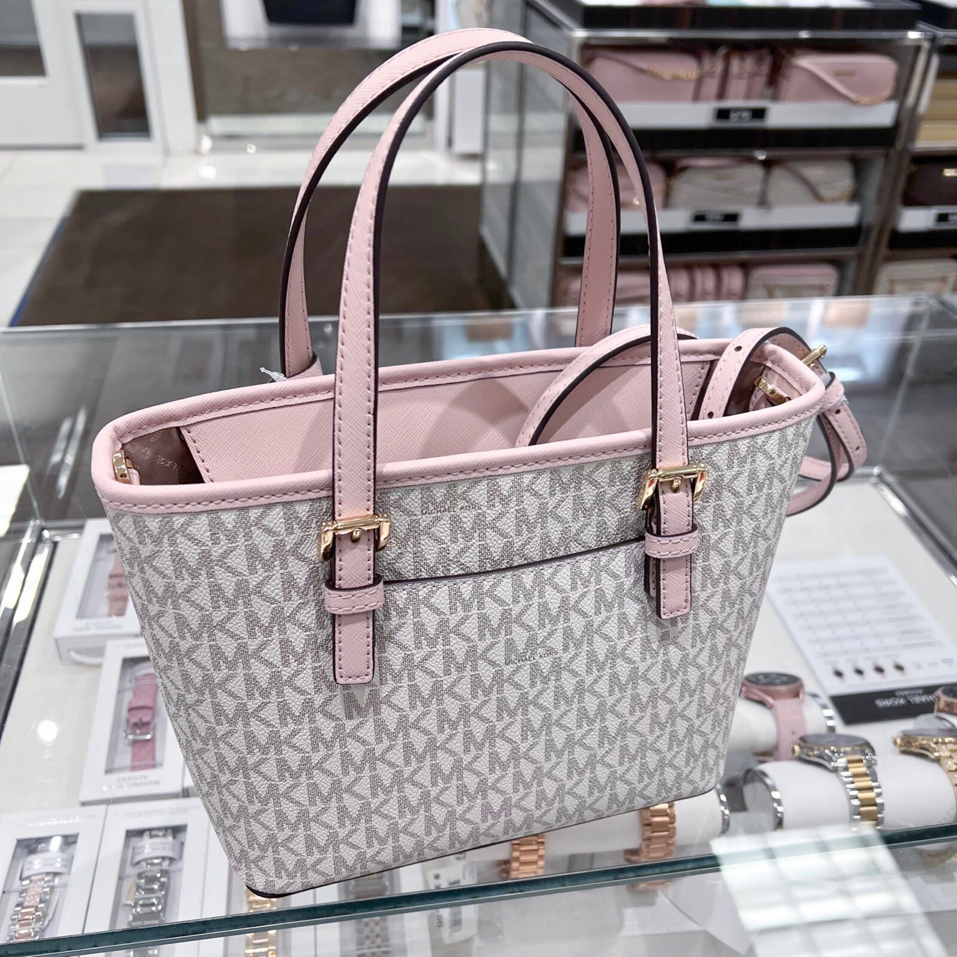 Michael Kors Tote Bag (Category: Luxury Bags & Wallets) located in Padre Garcia. Submitted by riailagan49560 (Listing ID 1418339359, Image 3). Description: - Michael Kors tote bag - Signature MK print - Pink trim and handles - Gold-tone logo charm - Top handle design - Main compartment - Small pocket - Stylish and versatile for everyday use.