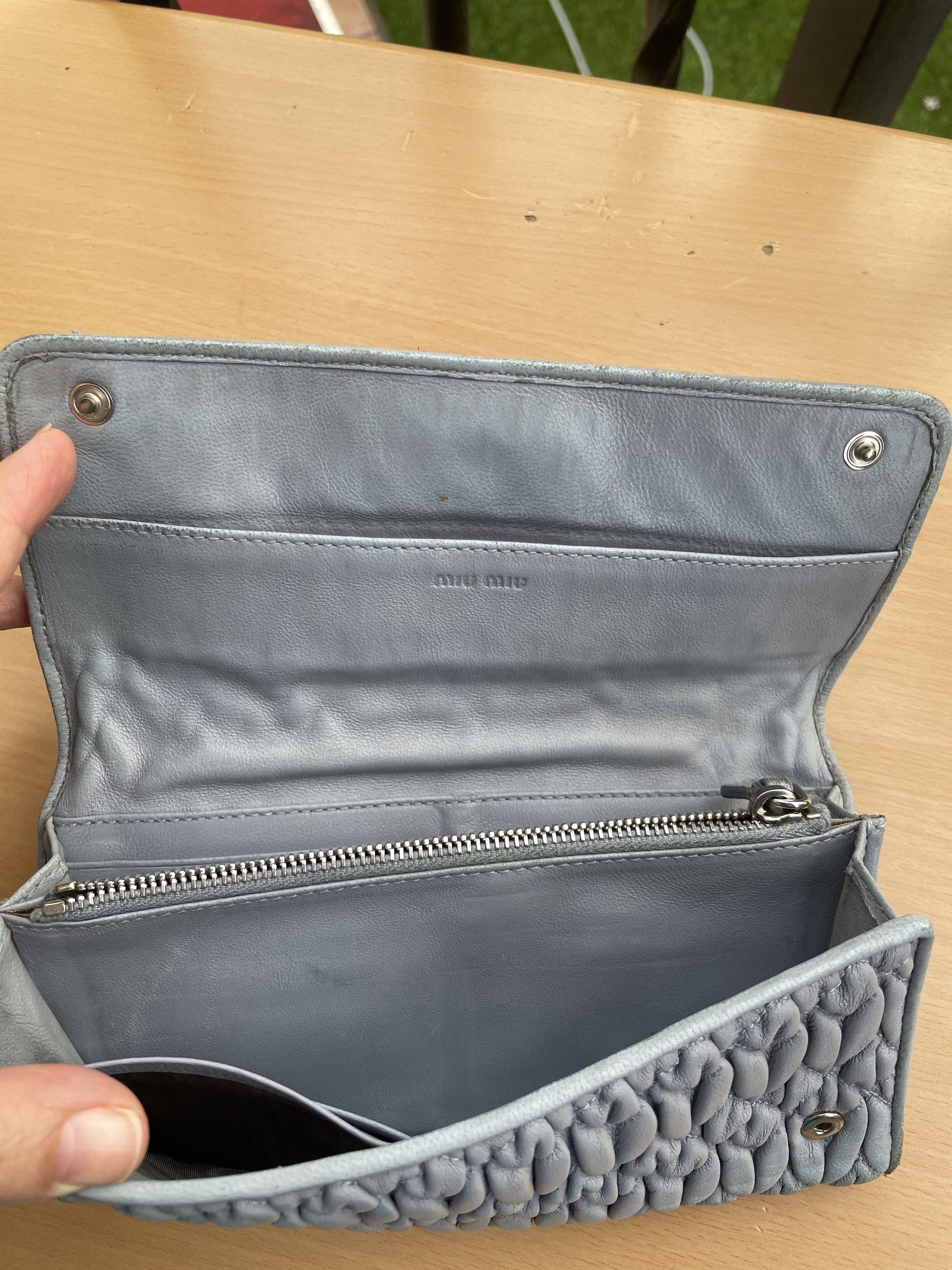 Miu Miu Quilted Leather Wallet (Category: Luxury Bags & Wallets) located in Makati City. Submitted by forbesclosetsale (Listing ID 1418305325, Image 2). Description: - Authentic Miu Miu wallet - Light blue quilted leather - Snap closure - Zippered compartment - Multiple card slots - Miu Miu logo visible - Shows wear on edges.