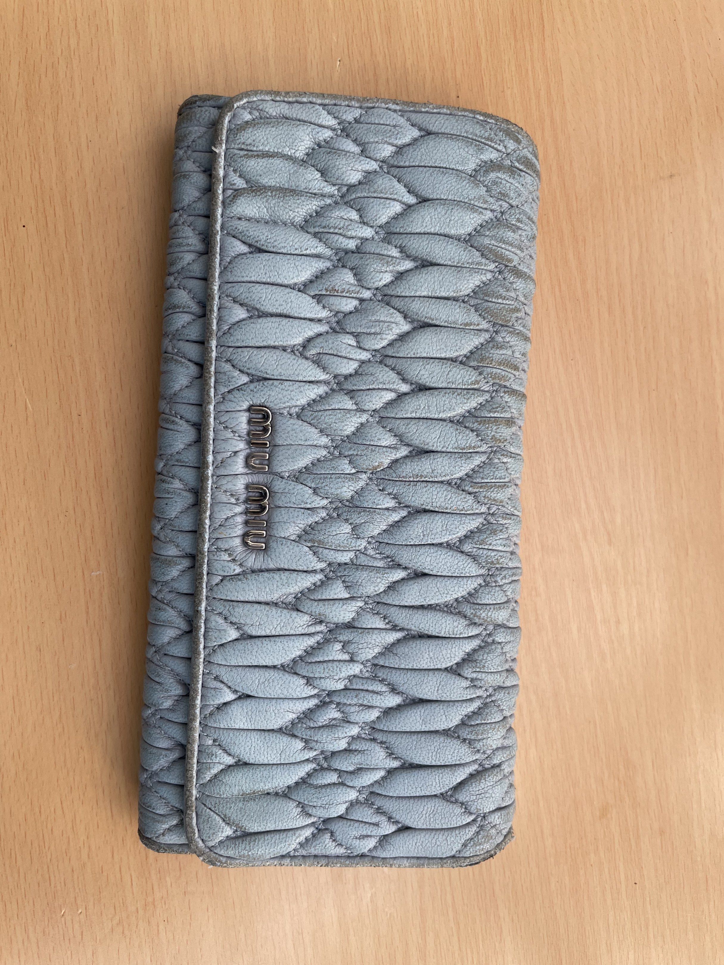 Miu Miu Quilted Leather Wallet (Category: Luxury Bags & Wallets) located in Makati City. Submitted by forbesclosetsale (Listing ID 1418305325, Image 1). Description: - Authentic Miu Miu wallet - Light blue quilted leather - Snap closure - Zippered compartment - Multiple card slots - Miu Miu logo visible - Shows wear on edges.
