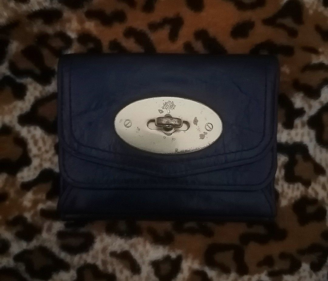 Mulberry Leather Wallet (Category: Luxury Bags & Wallets) located in Cebu City. Submitted by roadthrift (Listing ID 1418353883, Image 1). Description: Mulberry leather wallet in navy blue. It features a flap closure with a metal clasp. The interior includes multiple card slots and a coin compartment. The Mulberry logo is visible inside the wallet..