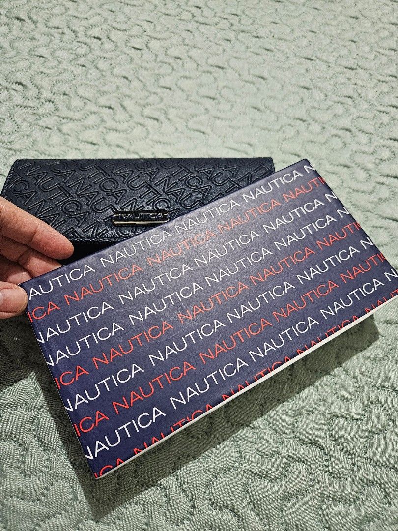 Nautica Navy Blue Wallet (Category: Wallets & Card holders) located in Manila. Submitted by closetcollection.ph (Listing ID 1418361343, Image 3). Description: - Brand new Nautica wallet - Navy blue color - Embossed Nautica logo - Multiple card slots - ID windows - Zippered compartment - RFID blocking protection - With original tags.