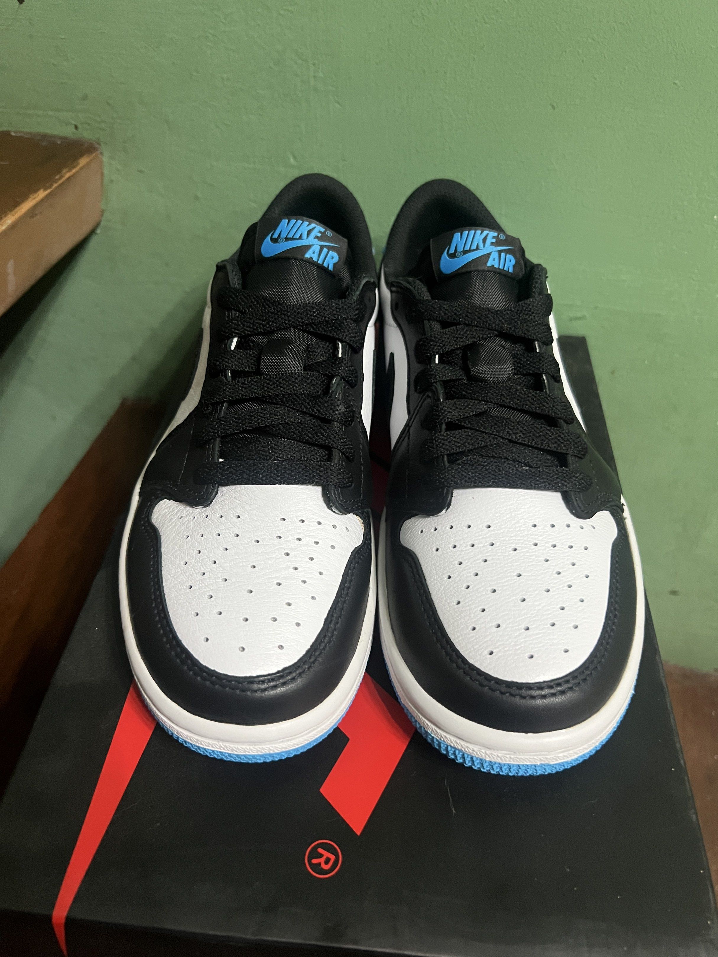 Nike Air Jordan 1 Retro Low OG (Category: Sneakers) located in Quezon City. Submitted by ammmilo (Listing ID 1418350040, Image 2). Description: The size is US 7, UK 4.5, EUR 38, and CM 24. Air Jordan 1 Retro Low OG in white, black, and blue colorway. Features the iconic Nike swoosh and Air Jordan logo. Includes the original box. The sole is blue. Brand New, Unfitted, Intact Box RFS: previously collecting, downsizing storage Everything must go 🙏�