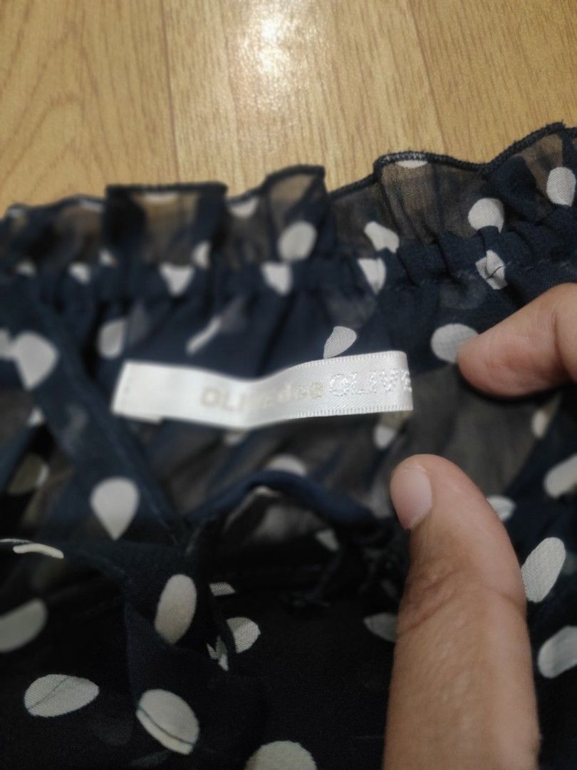 OLIVE des OLIVE Polka Dot Off-Shoulder Top (Category: Blouses) located in Dasmarinas. Submitted by amara1022 (Listing ID 1418227437, Image 2). Description: - OLIVE des OLIVE off-shoulder top - Playful polka dot pattern - Short sleeves - Ruffled hem - Lightweight and semi-sheer fabric - Includes tag with Japanese characters - Versatile for various outfits.
