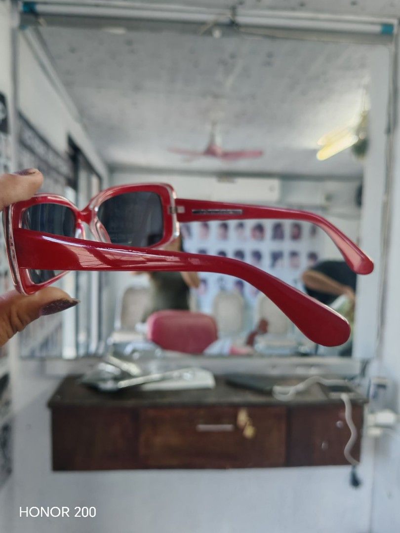 Red Sunglasses (Category: Sunglasses & Eyewear) located in Valenzuela. Submitted by japansurplus2020 (Listing ID 1418347367, Image 1). Description: - Stylish red sunglasses - Rectangular frame with dark lenses - Brand logo on arms - Perfect for everyday wear - Provides sun protection.