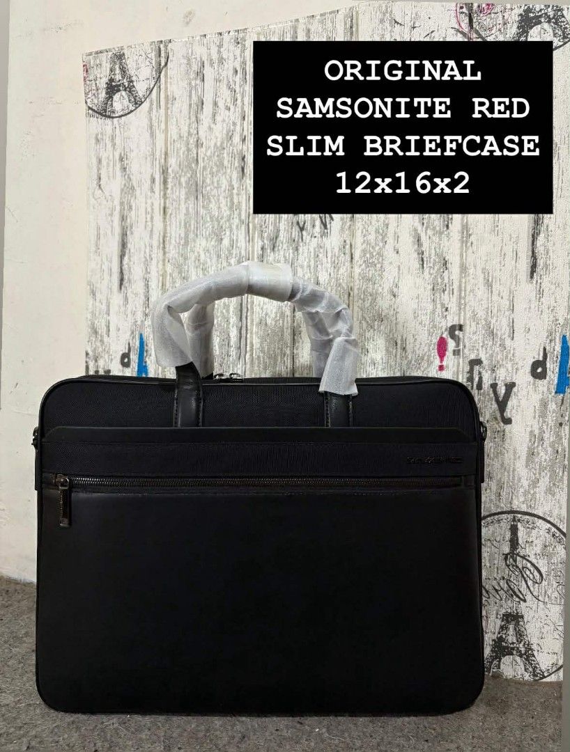 Samsonite Red Slim Briefcase 12x16x2 (Category: Briefcases) located in Manila. Submitted by jzjapansurplus (Listing ID 1418282443, Image 1). Description: - Original Samsonite Red slim briefcase - Black exterior - Zippered main compartment - Front zippered pocket - Detachable shoulder strap - Original packaging included - Dimensions: Approximately 12x16x2 inches.