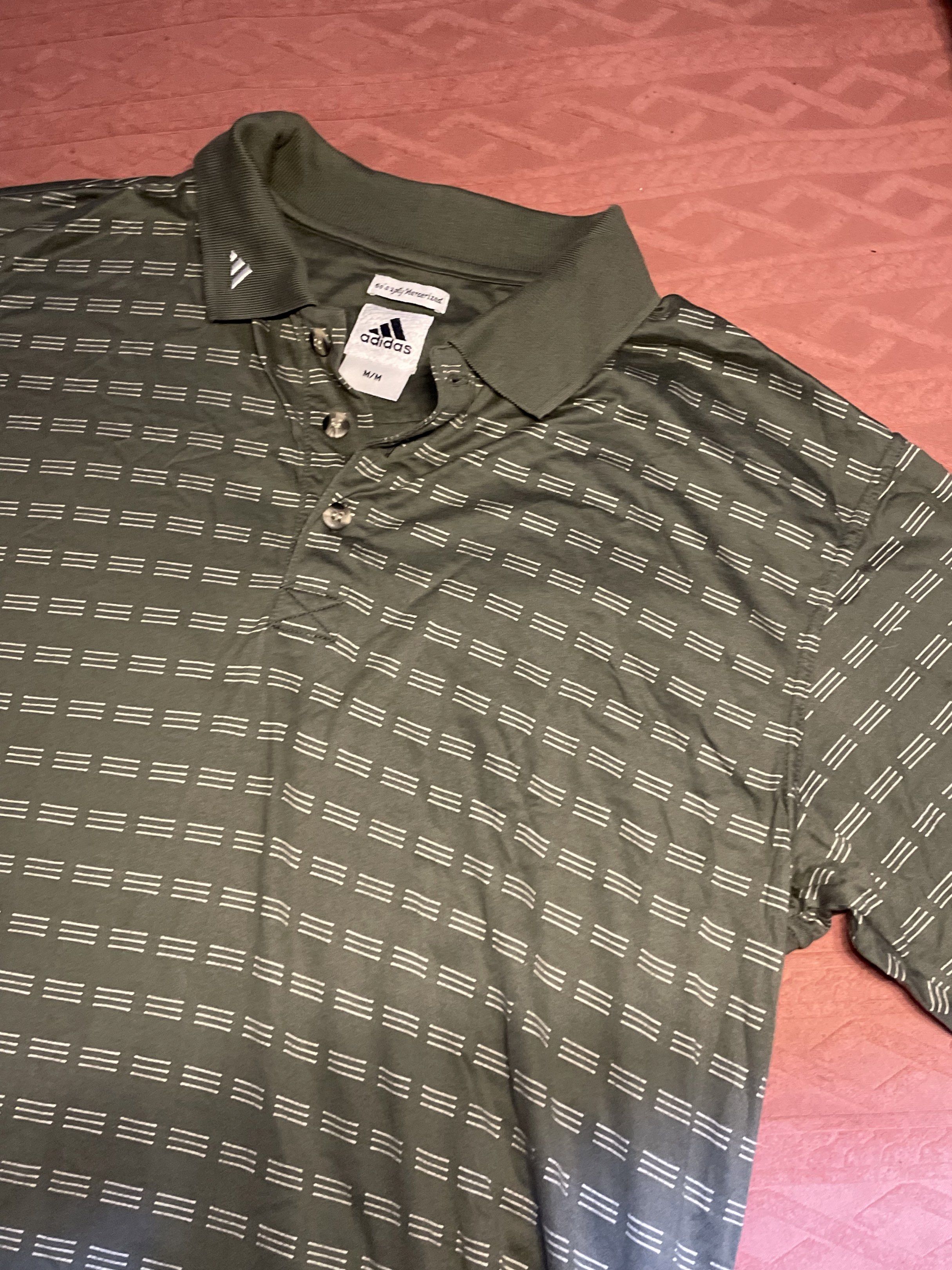 Vintage Adidas Polo Shirt Medium (Category: Tshirts & Polo Shirts ) located in Quezon City. Submitted by augustus666 (Listing ID 1418294370, Image 1). Description: - Adidas polo shirt - Olive green color - Geometric pattern - Adidas logo on chest and collar - Collared neckline - Button-down closure - Size: M-L.