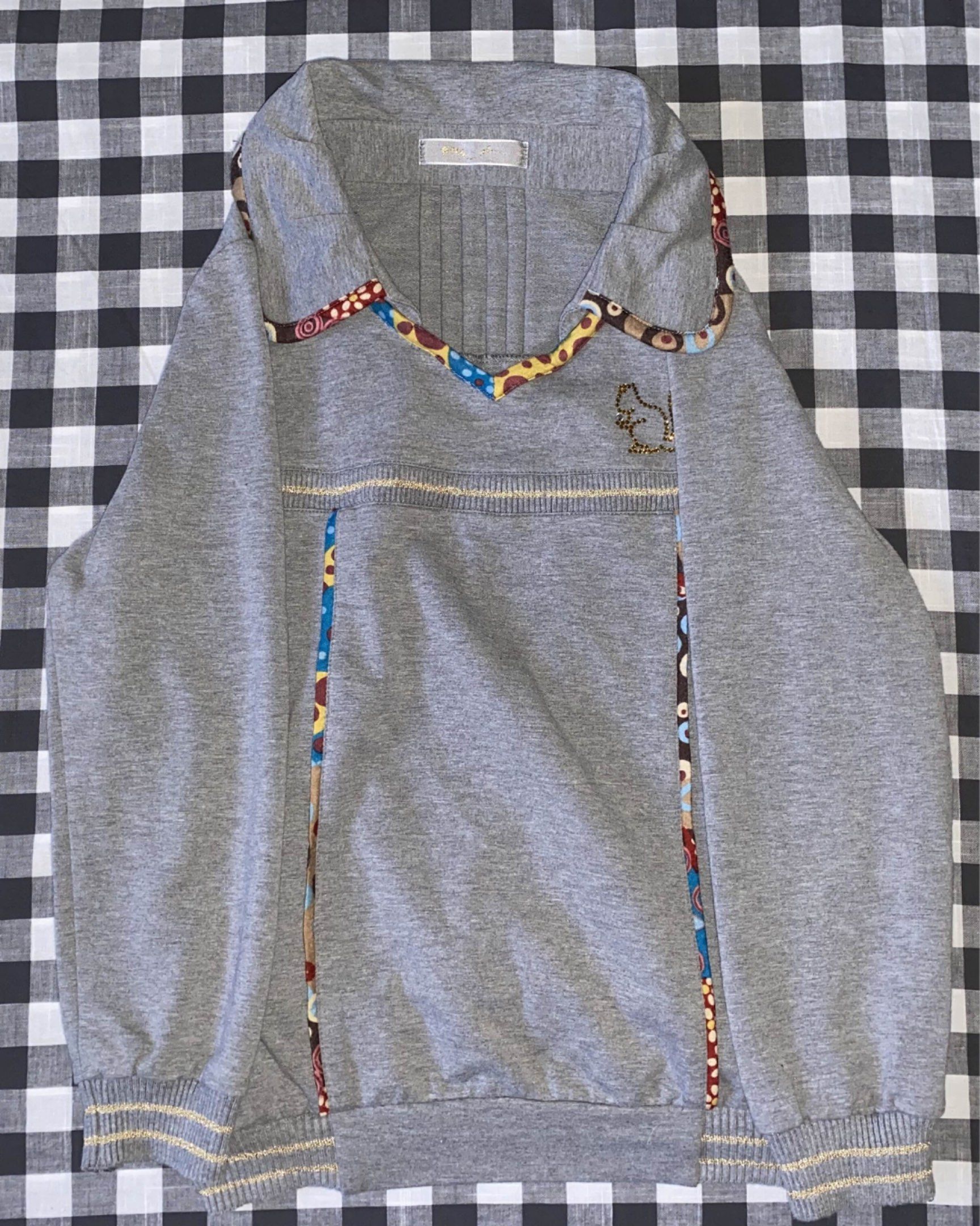Whimsy Gray Sweatshirt with Squirrel Embroidery (Category: Longsleeves) located in Manila. Submitted by caimixed (Listing ID 1418403228, Image 1). Description: - Gray sweatshirt - Unique design with colorful patterned accents on collar and sides - Small embroidered squirrel on chest - Collared neckline - Ribbed cuffs and hem - Comfortable and stylish Complete rhinestones!!!.